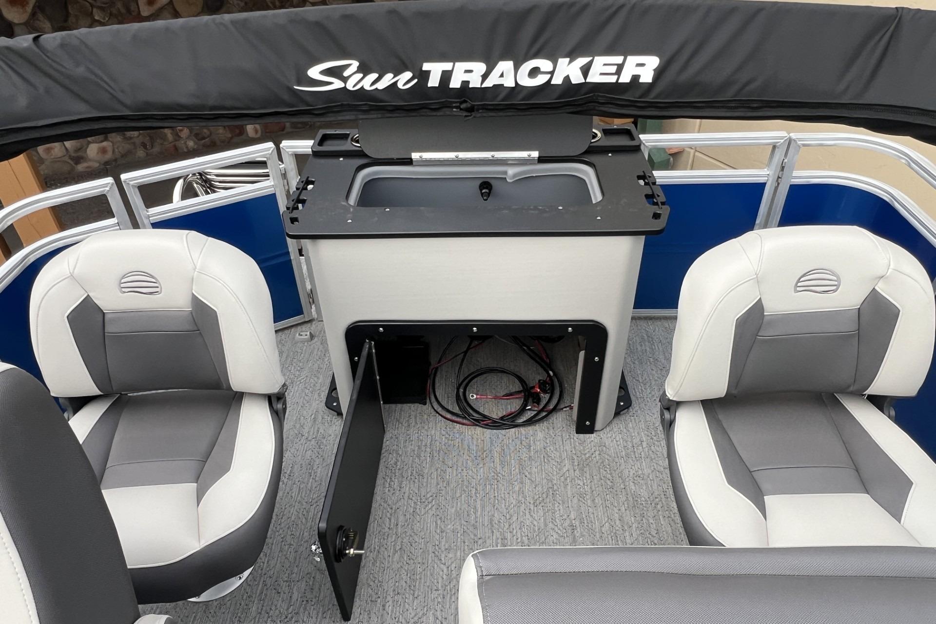 2026 Sun Tracker Fishin' Barge 20 DLX interior with seating and storage.