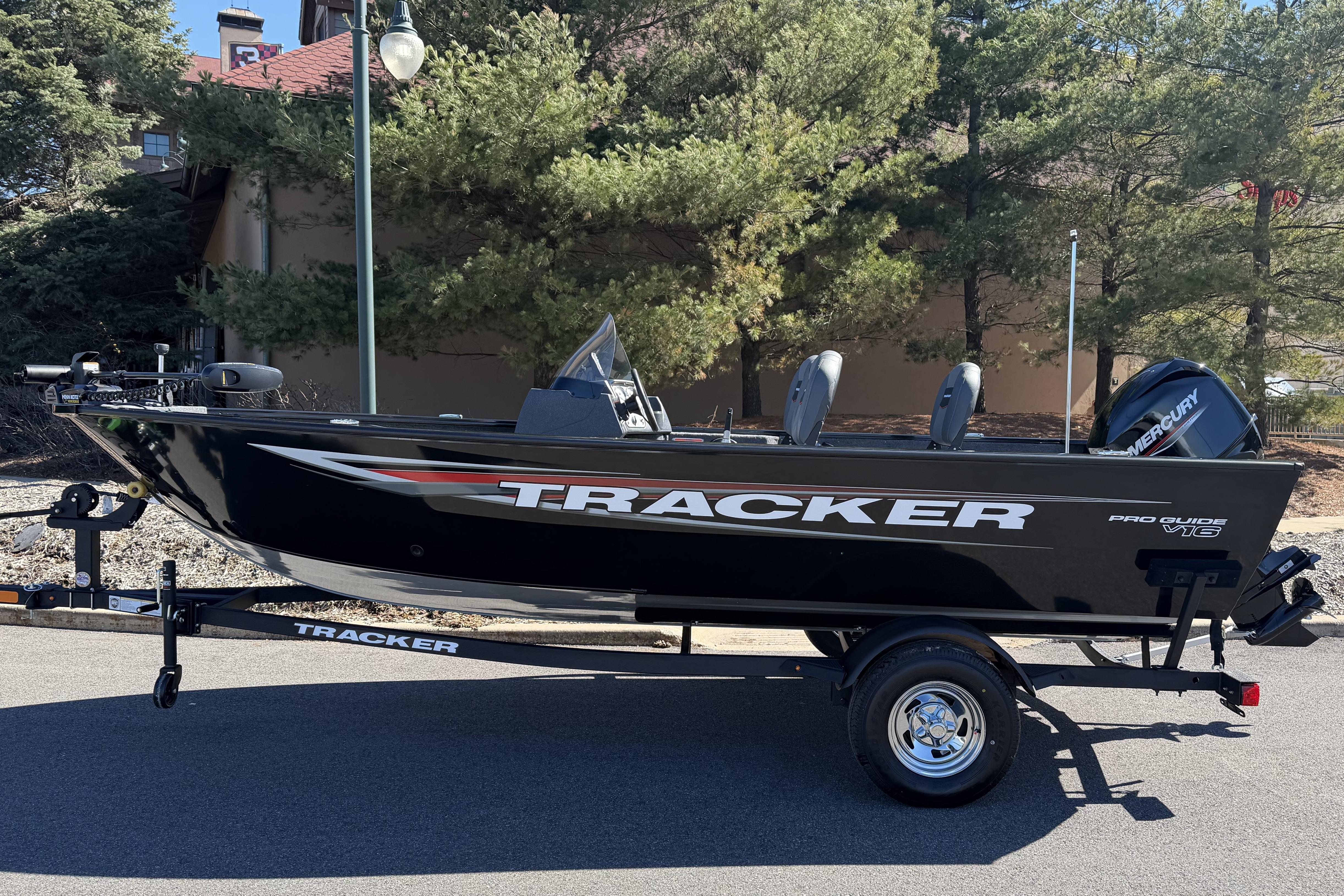 2026 Tracker Pro Guide V-16 SC boat on trailer, parked outdoors.