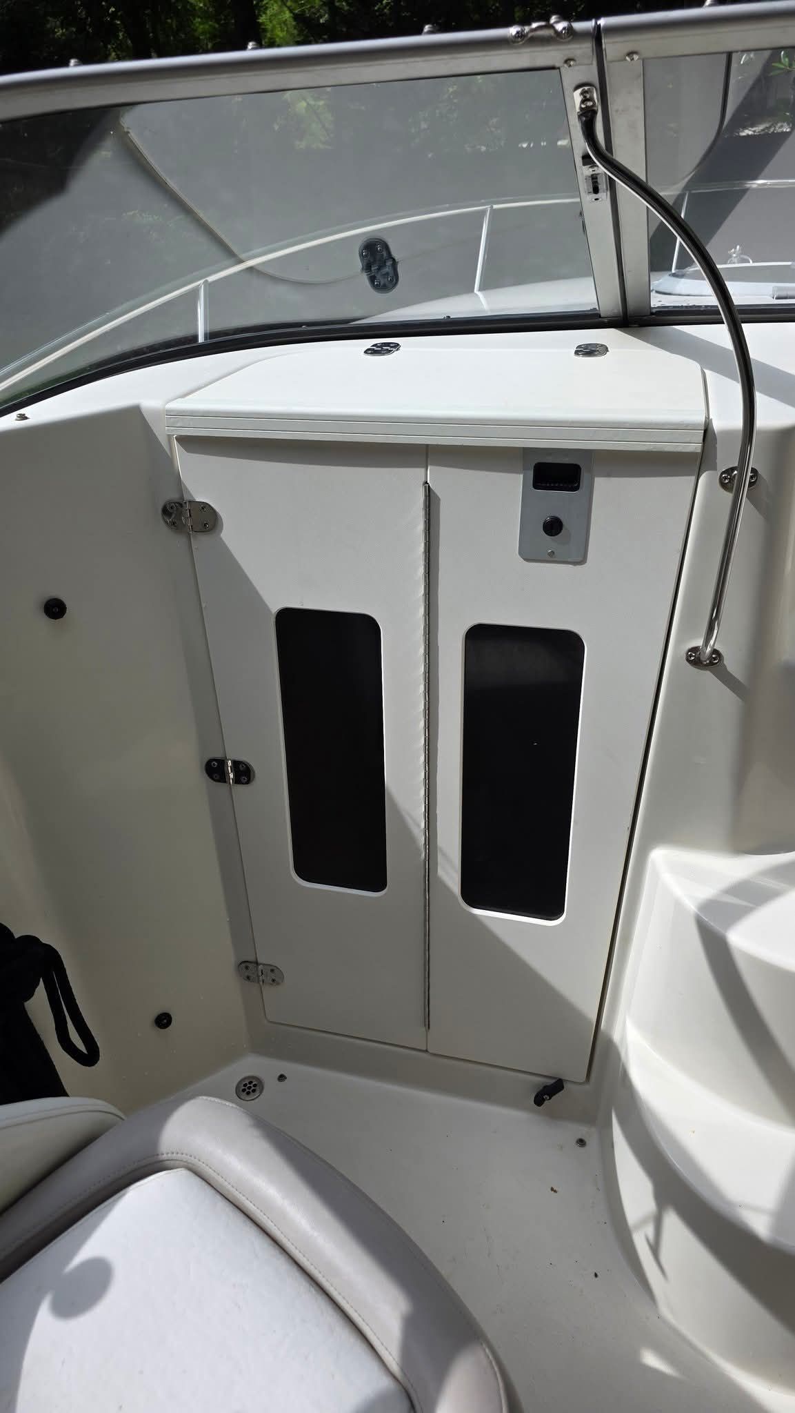 Interior view of a 2006 Stingray 250 CR with white cabinets and seating area.