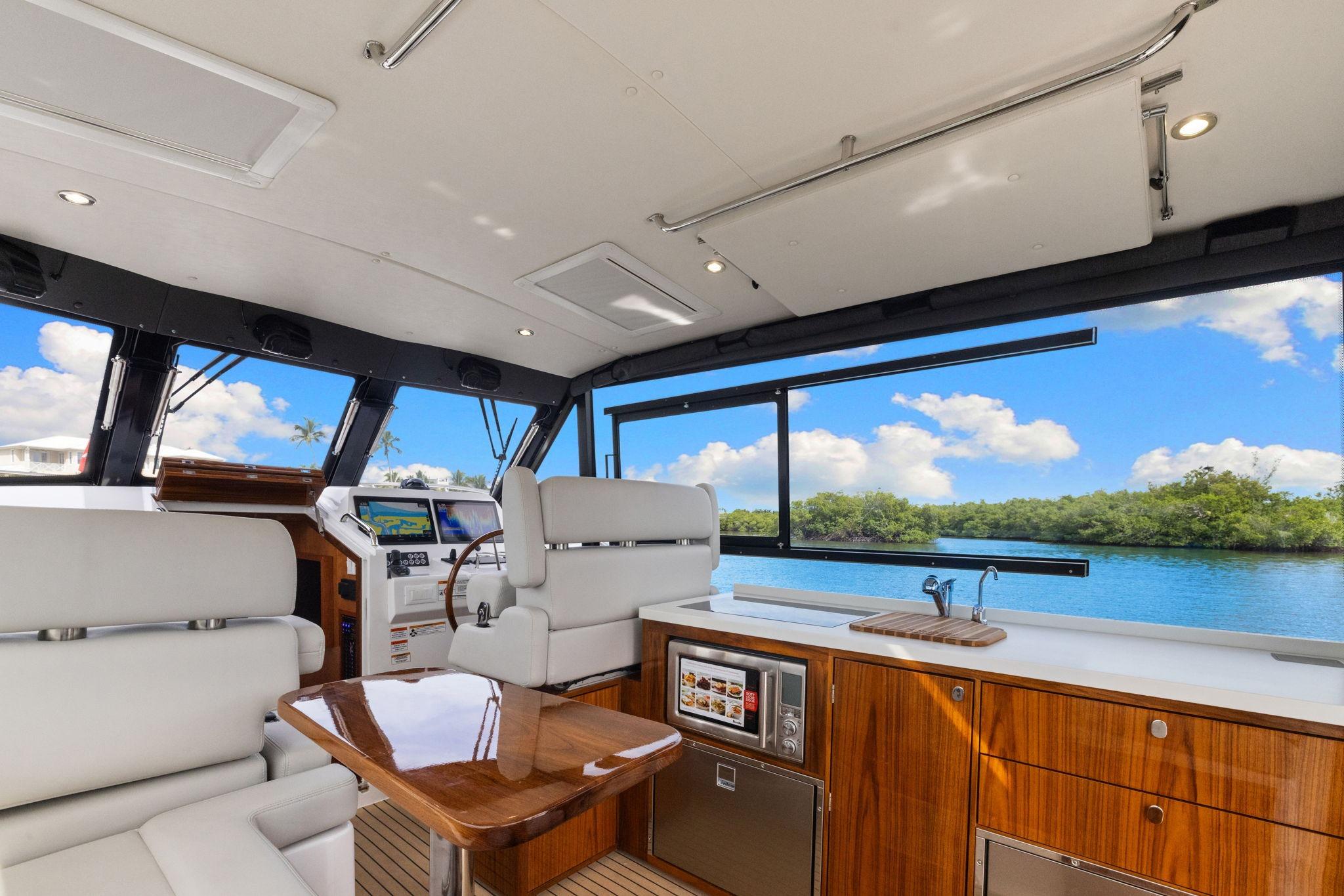 Luxurious interior of 2024 MJM 42 yacht with scenic water view.