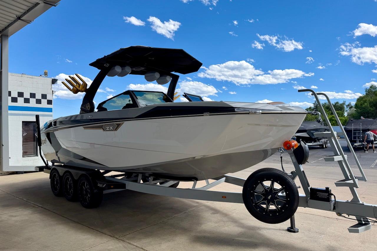 2025 Tigé Ultré 25ZX boat on trailer under clear blue sky.