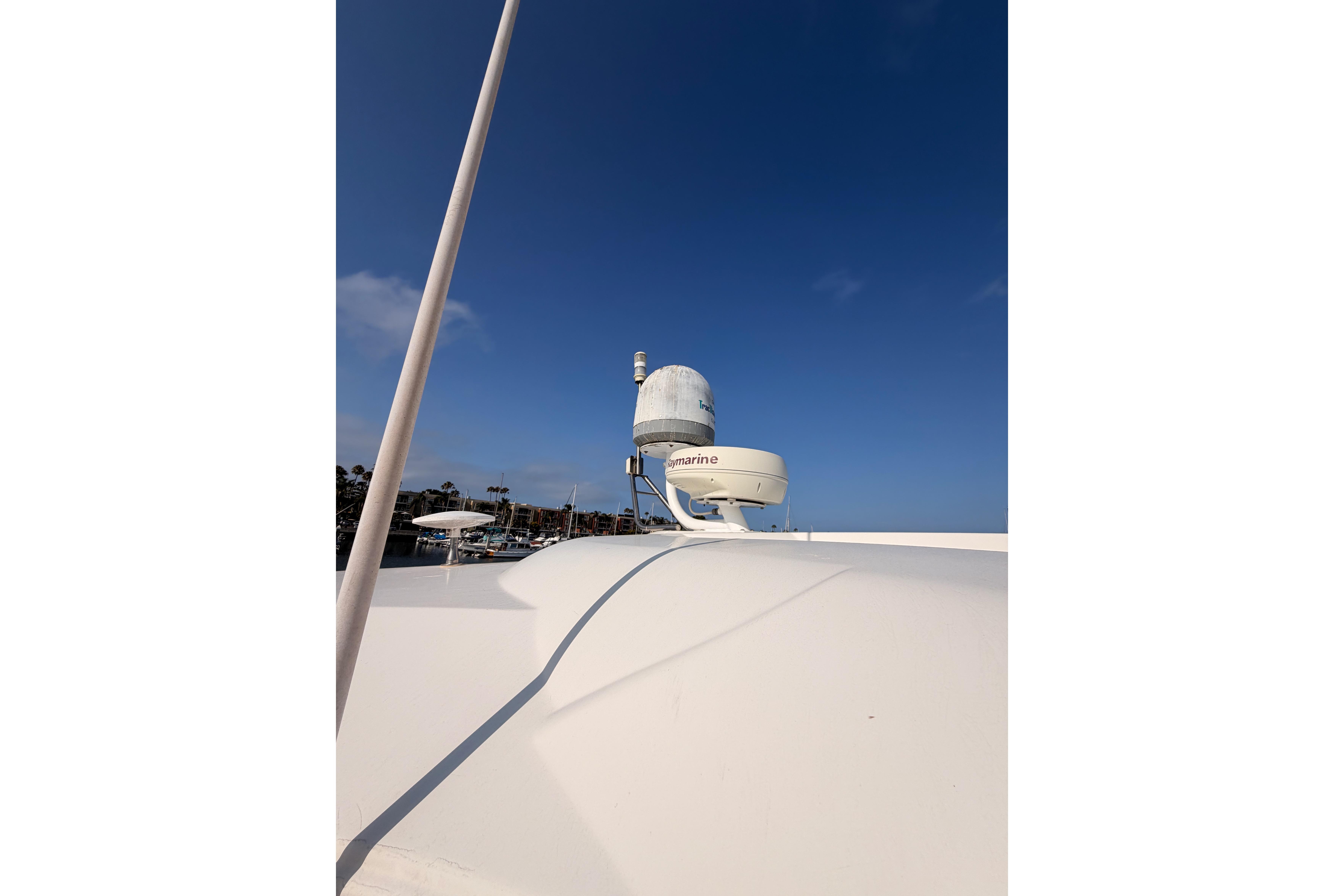 Radar equipment on 2005 Cruisers Yachts 405 Express Motoryacht against clear blue sky.