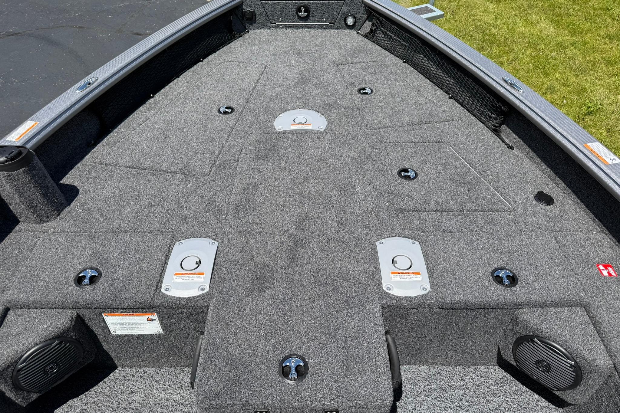 2027 Lund 1875 Pro Guide boat deck with carpeted surface and storage compartments.