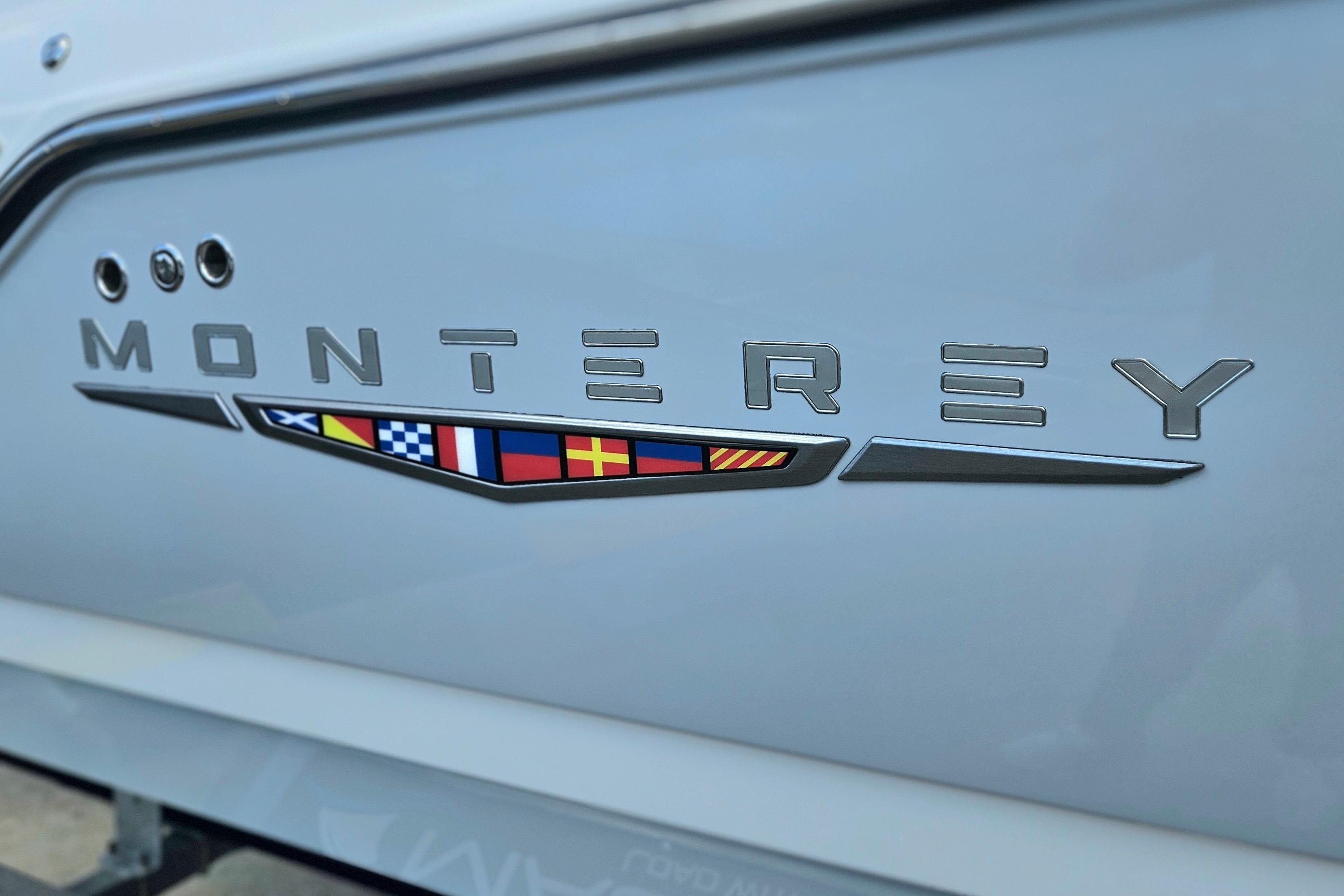 Monterey Elite 25 OB 2026 boat logo with nautical flag design.