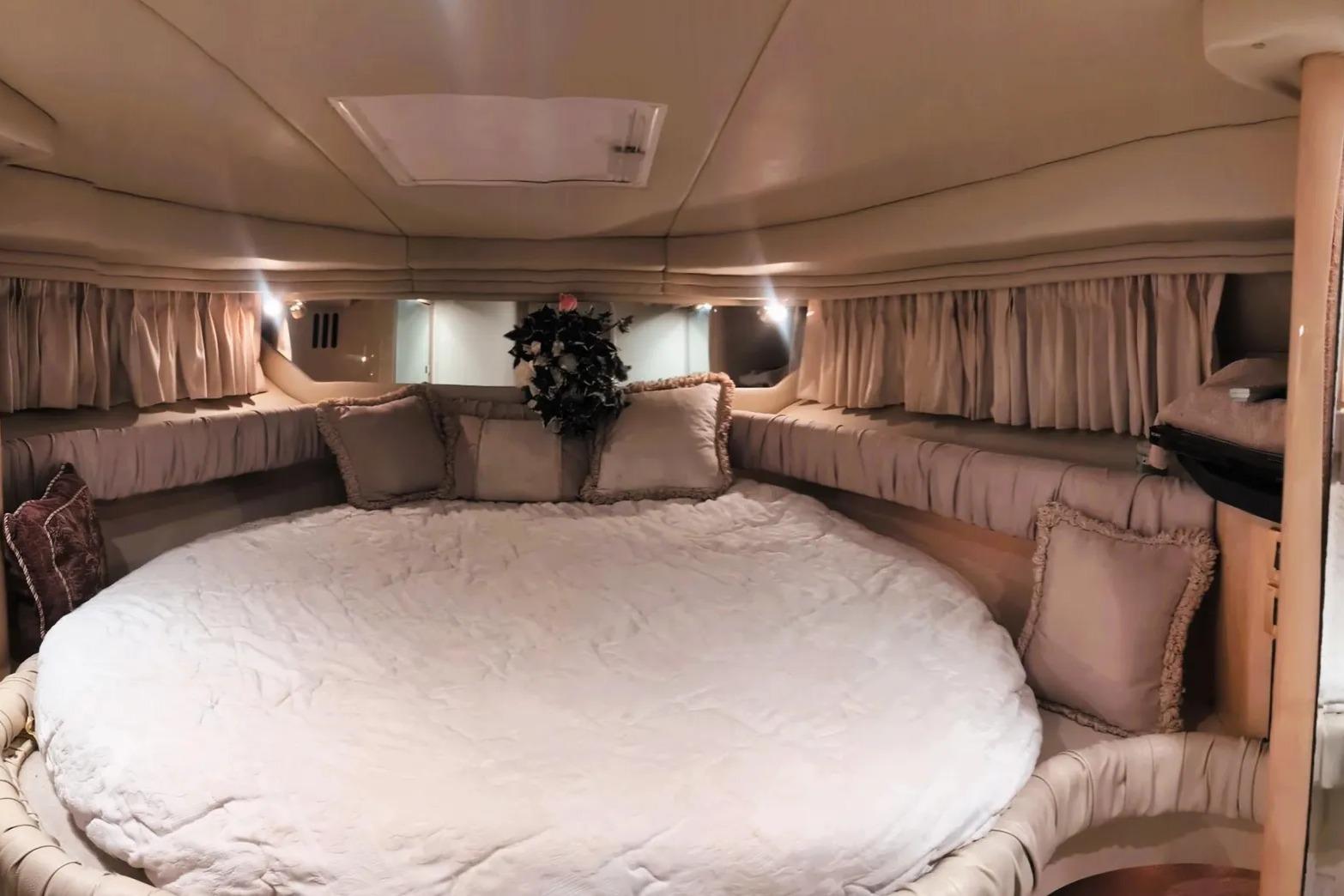 Luxurious interior cabin of 2000 Sea Ray 380 Sundancer yacht with plush bedding.