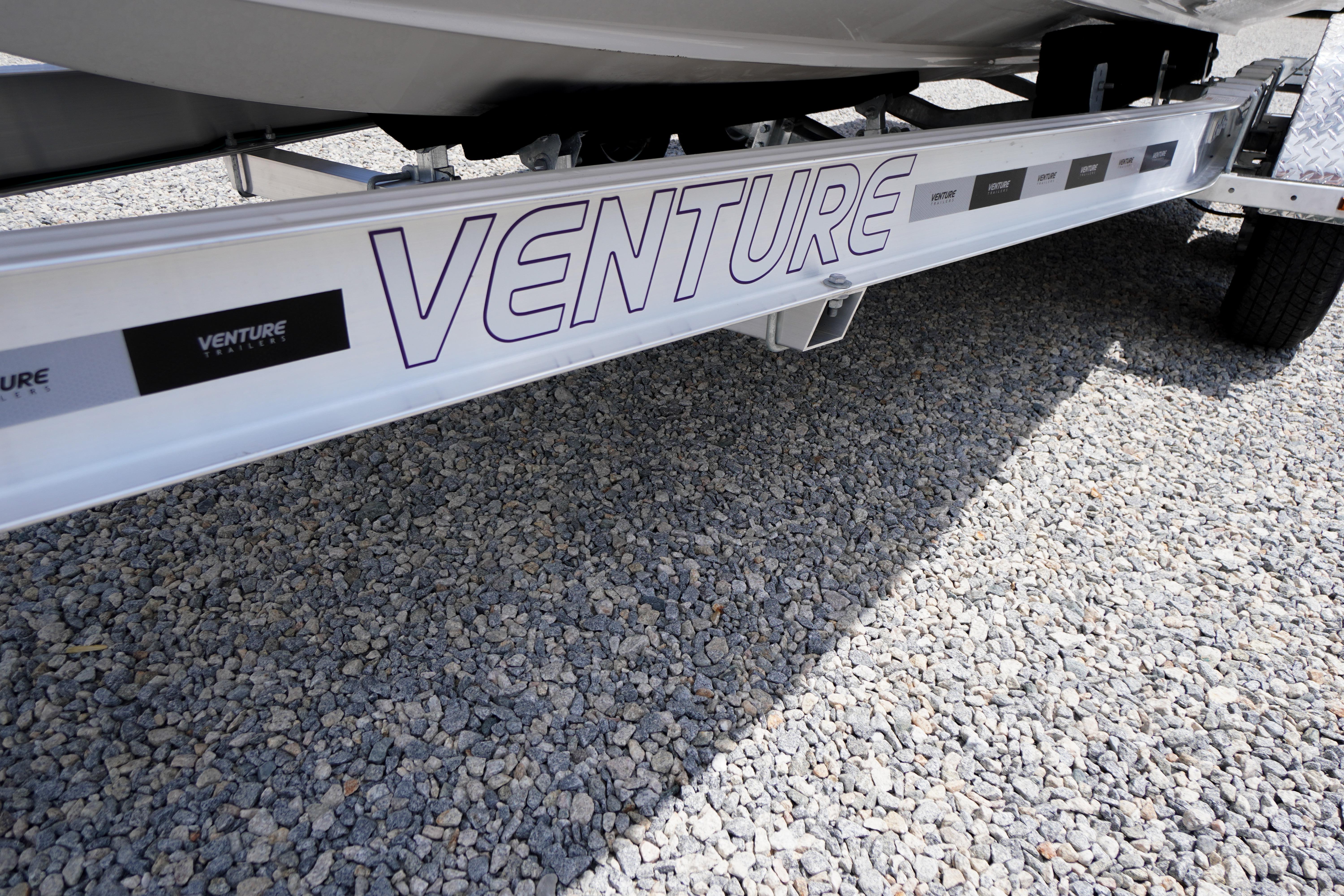 Trailer for 2026 Chaparral SSX 4 boat on gravel surface.