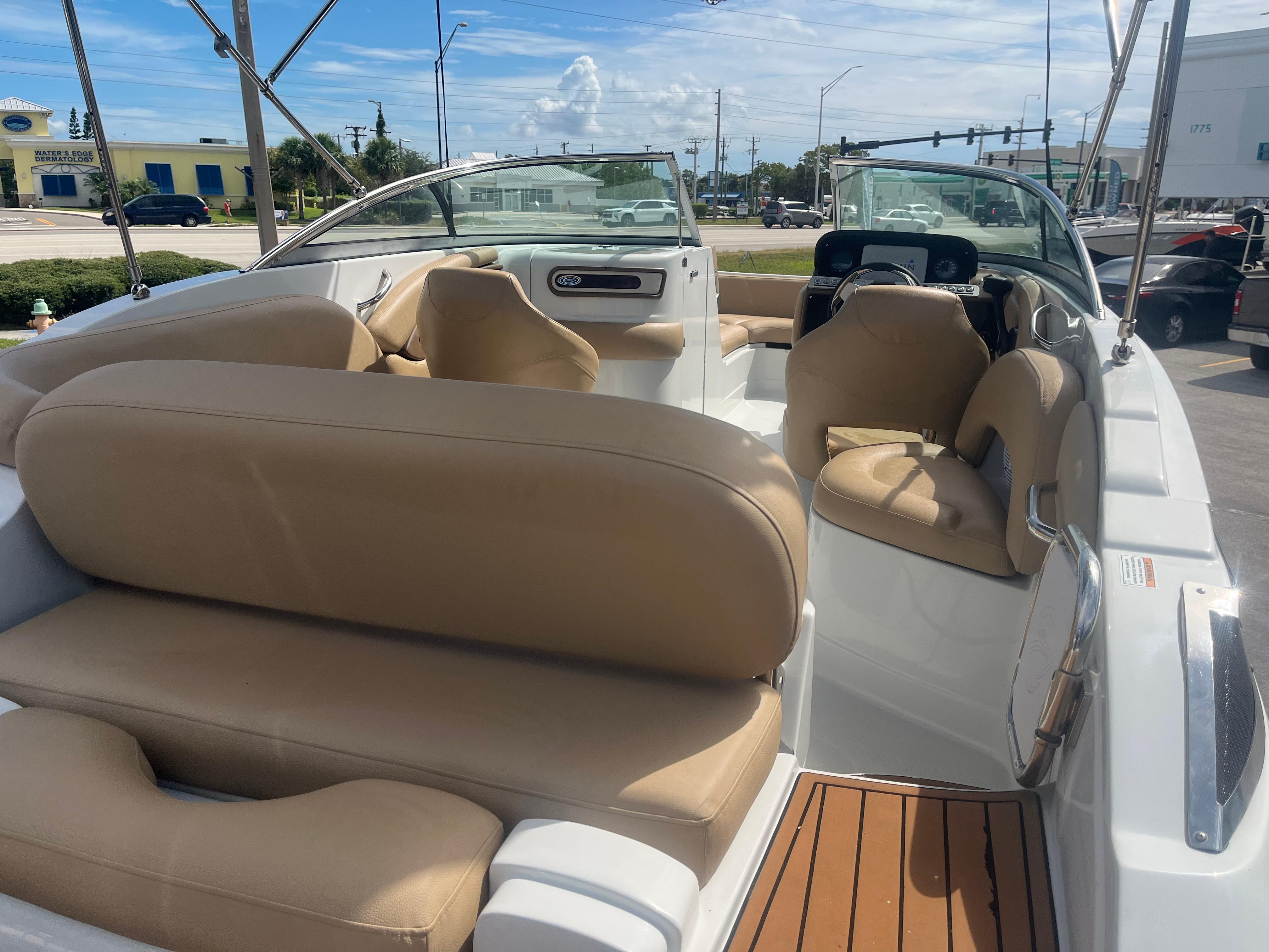 2022 Crownline Eclipse E235 XS boat interior with beige seating and modern dashboard.