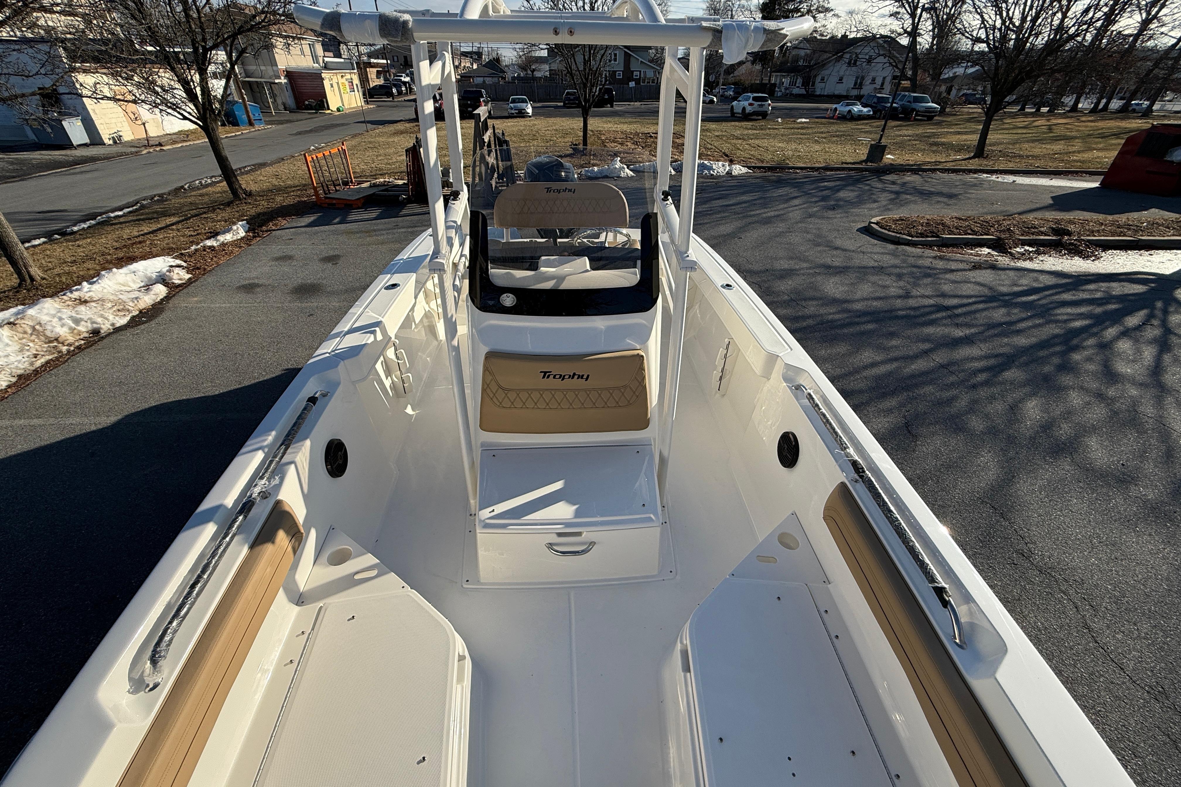 2026 Bayliner Trophy T22CC boat interior with seating and console, parked outdoors.