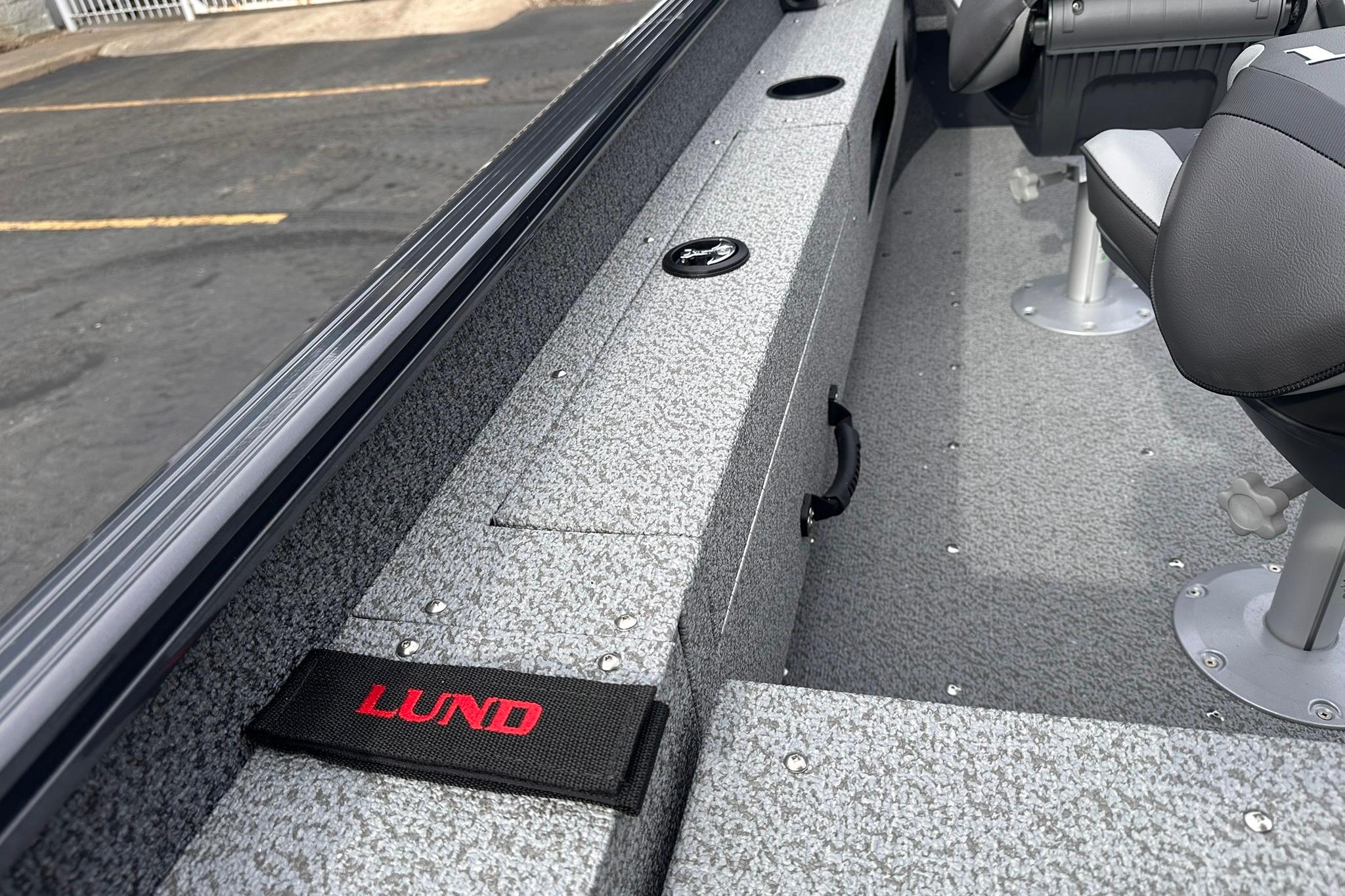 2026 Lund 1775 Adventure Sport boat interior with seating and storage compartments.