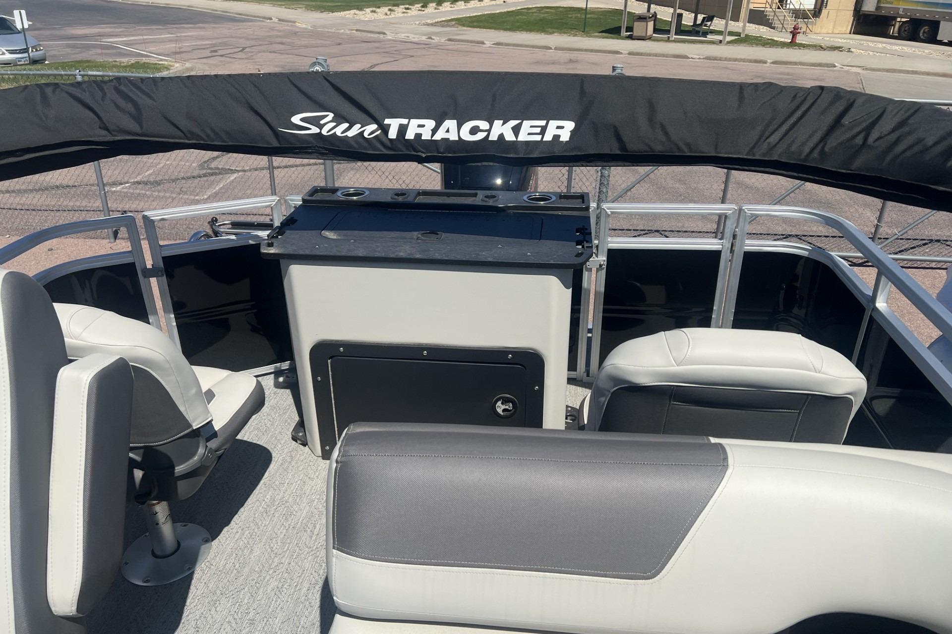 2026 Sun Tracker Fishin' Barge 20 DLX interior with seating and console.