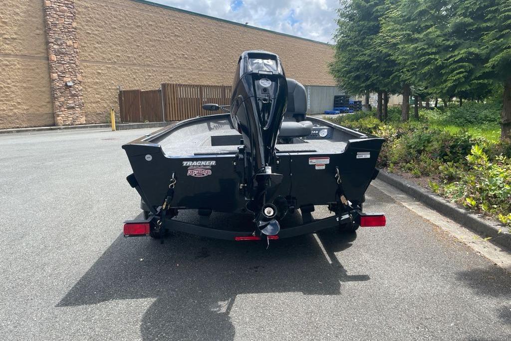 2025 Tracker Super Guide V-16 T boat parked outdoors, rear view.