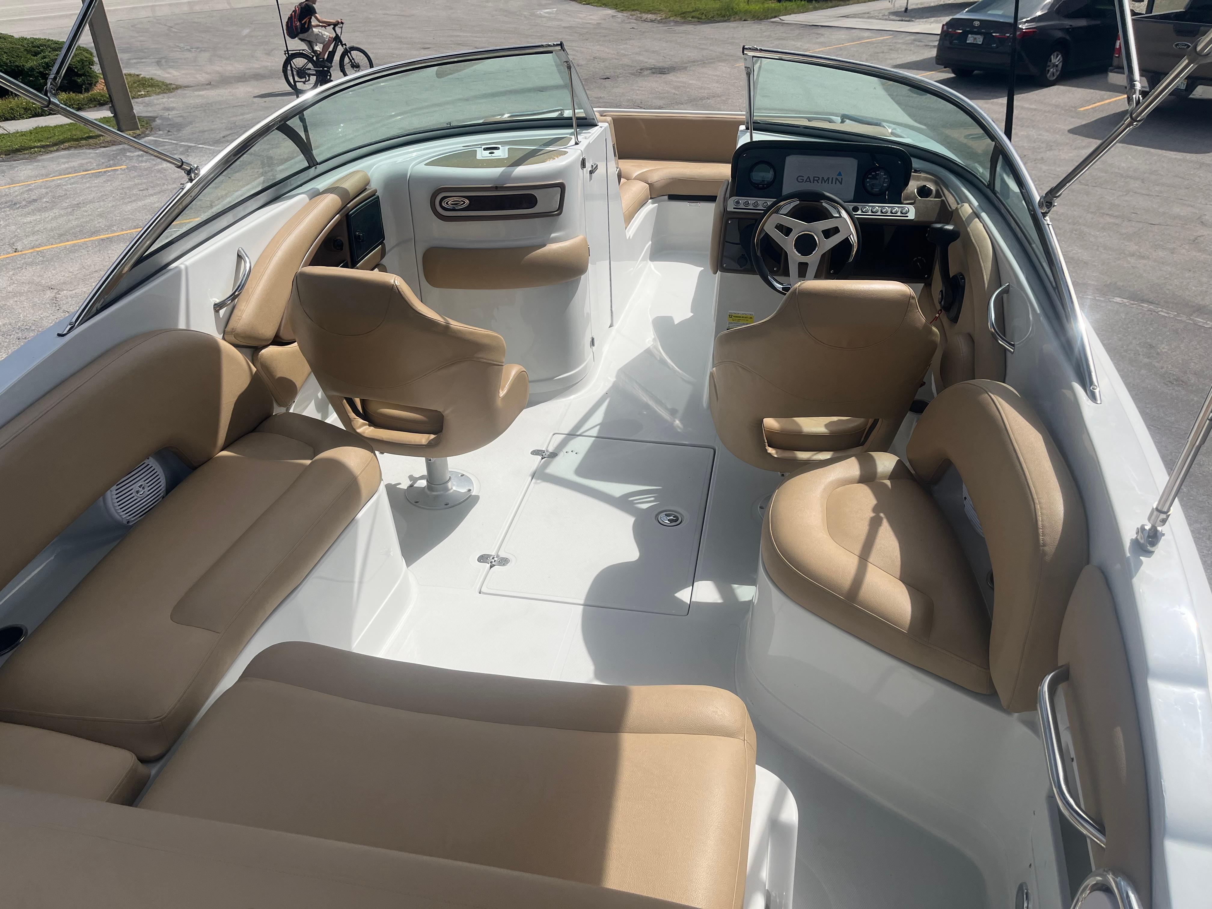 2022 Crownline Eclipse E235 XS boat interior with tan seating and modern dashboard.