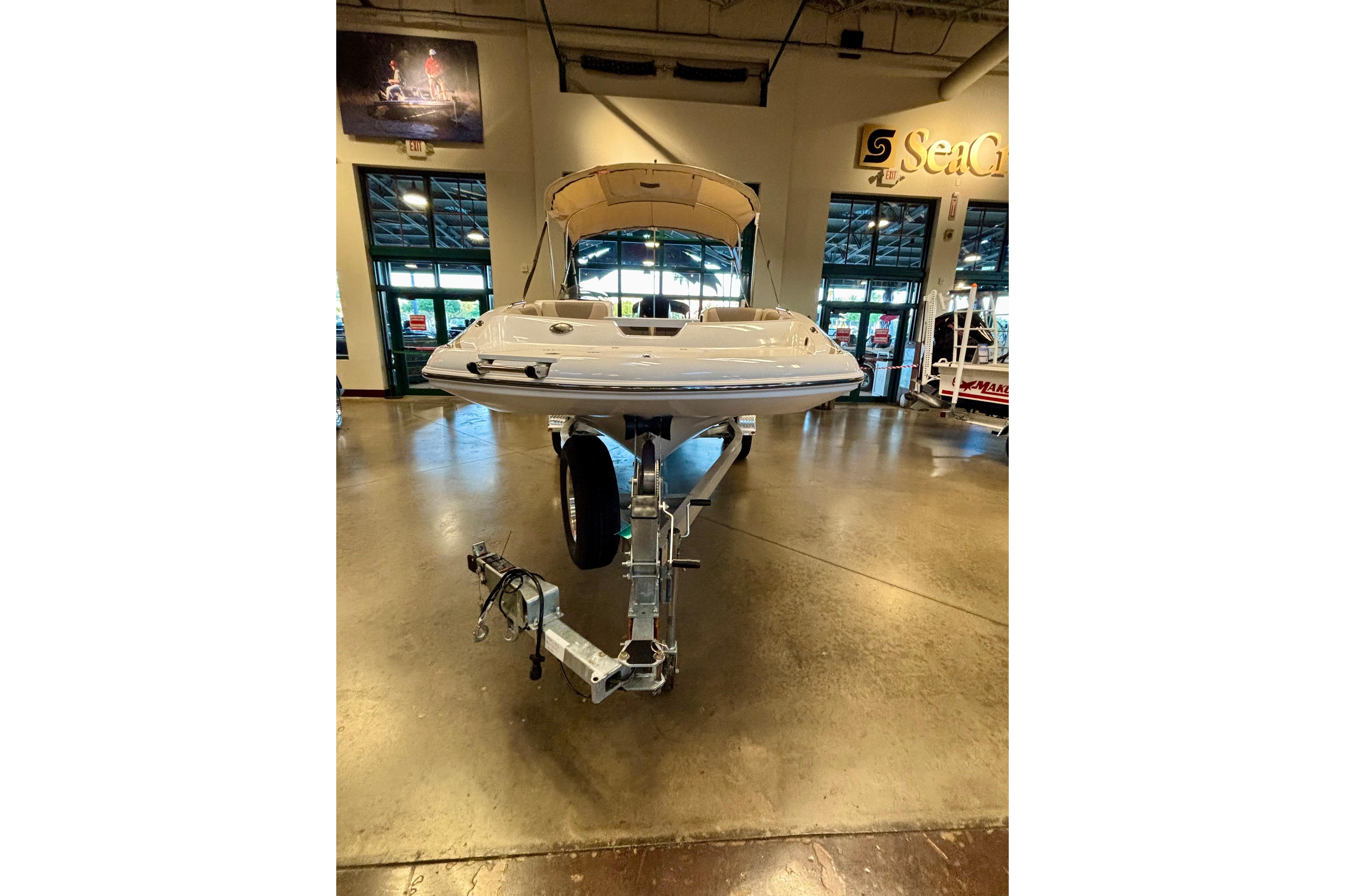 2026 Tahoe 2150 boat displayed indoors on a trailer, showcasing sleek design.