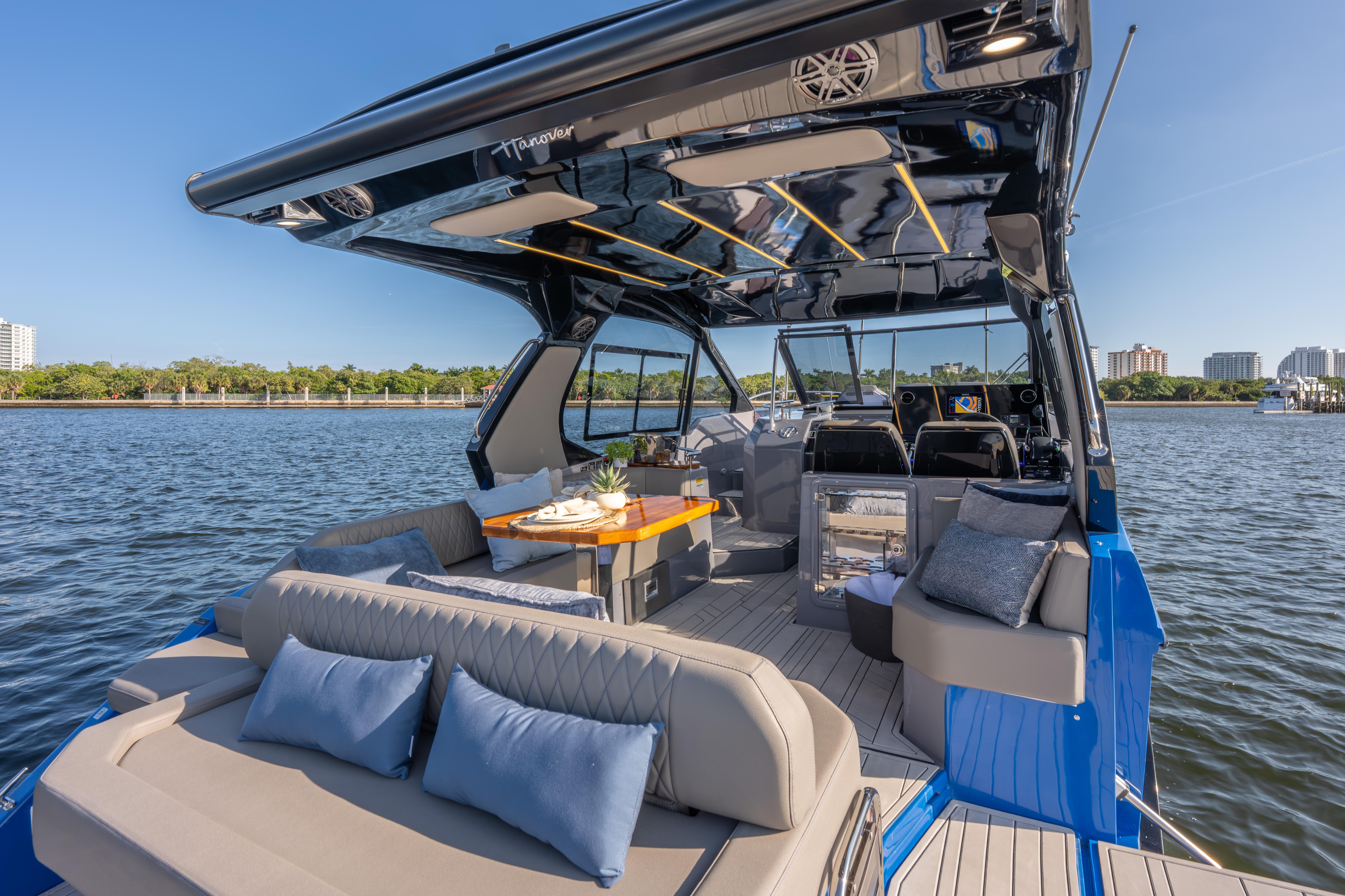 Luxurious 2026 Hanover 347 yacht interior with elegant seating and dining area on the water.
