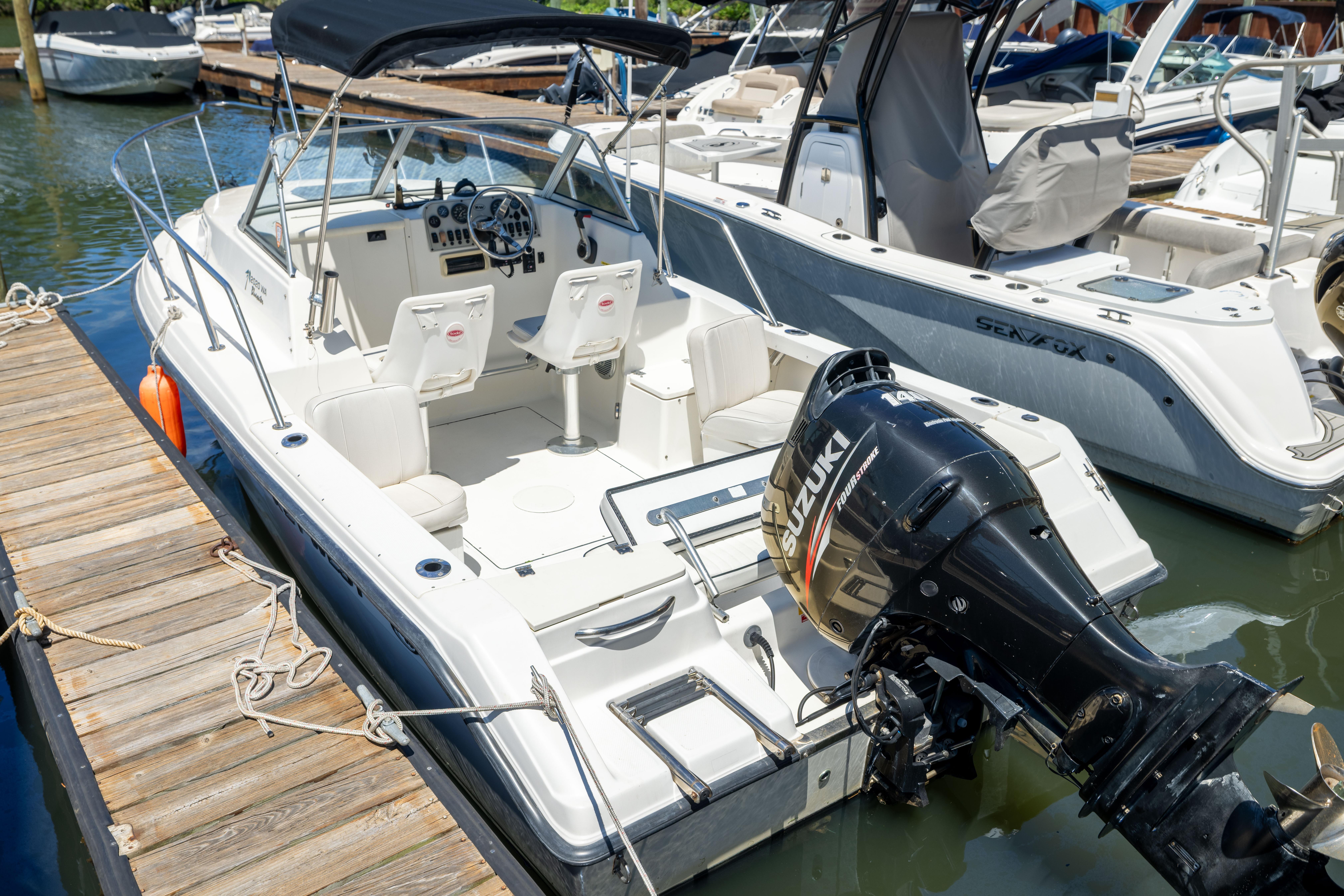 2020 KEYWEST WA boat docked, featuring Suzuki outboard motor, spacious seating, and sleek design.