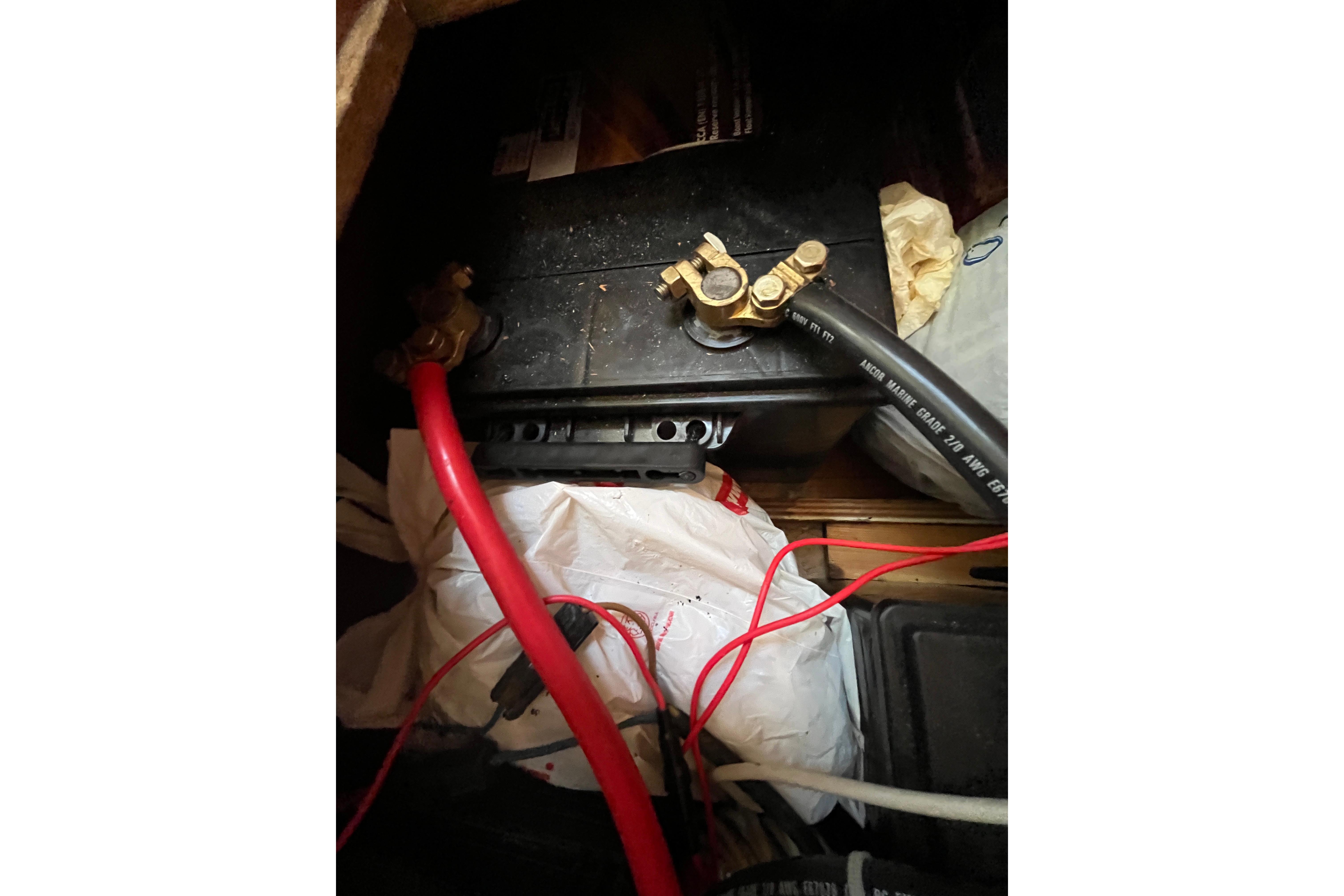 Battery compartment with cables in a 1995 Belliure 41 yacht.