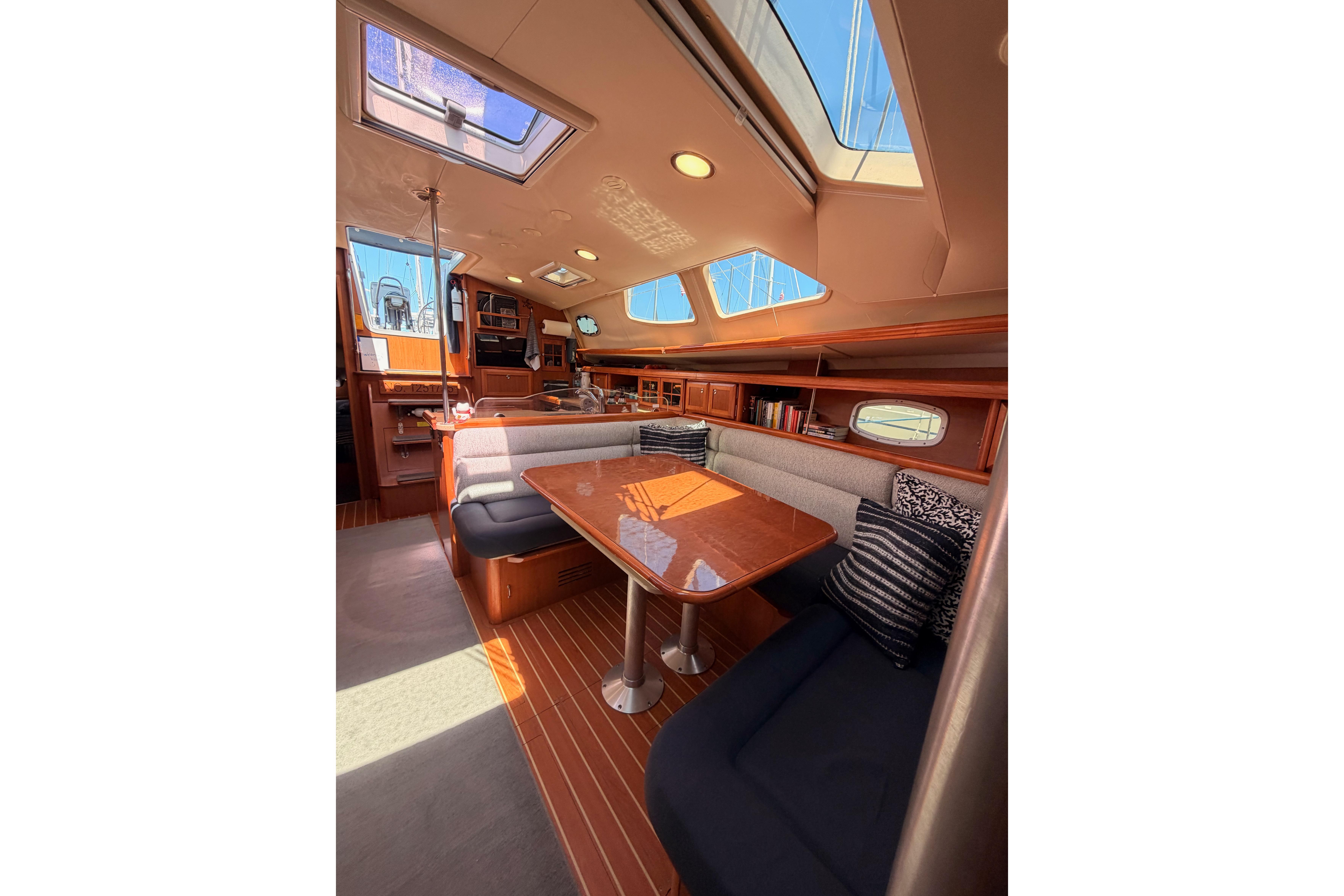 Luxurious interior of 2008 Hunter 45 Deck Salon yacht with elegant seating and skylights.