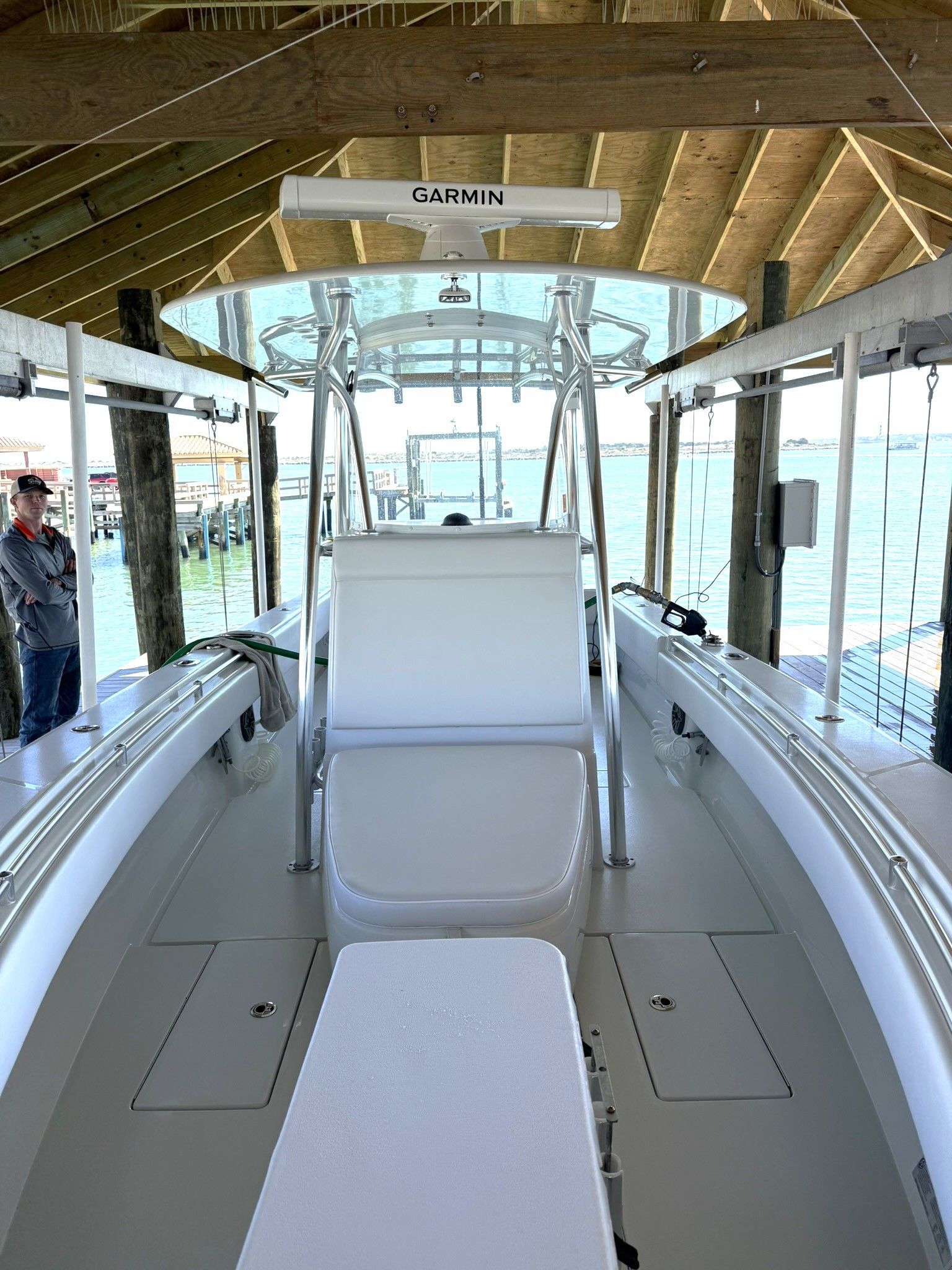 Contender 32 ST 2025 boat under covered dock with Garmin equipment.
