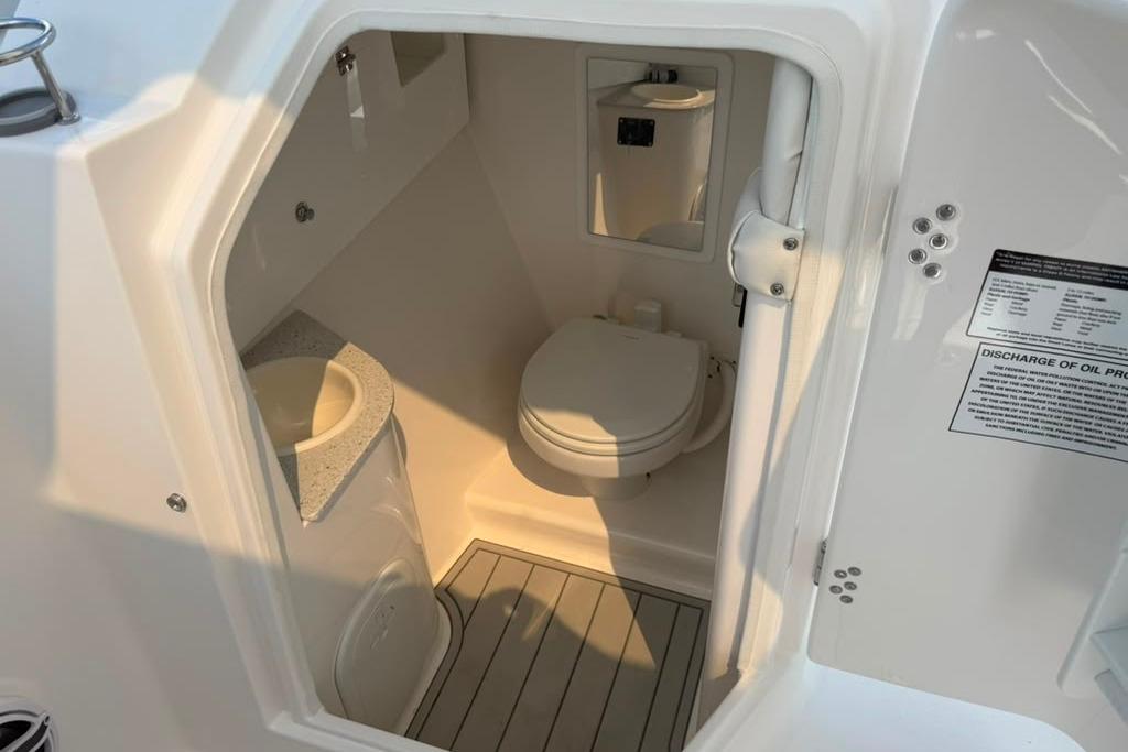Interior view of 2026 Sea Fox 288 Traveler boat bathroom with toilet and sink.