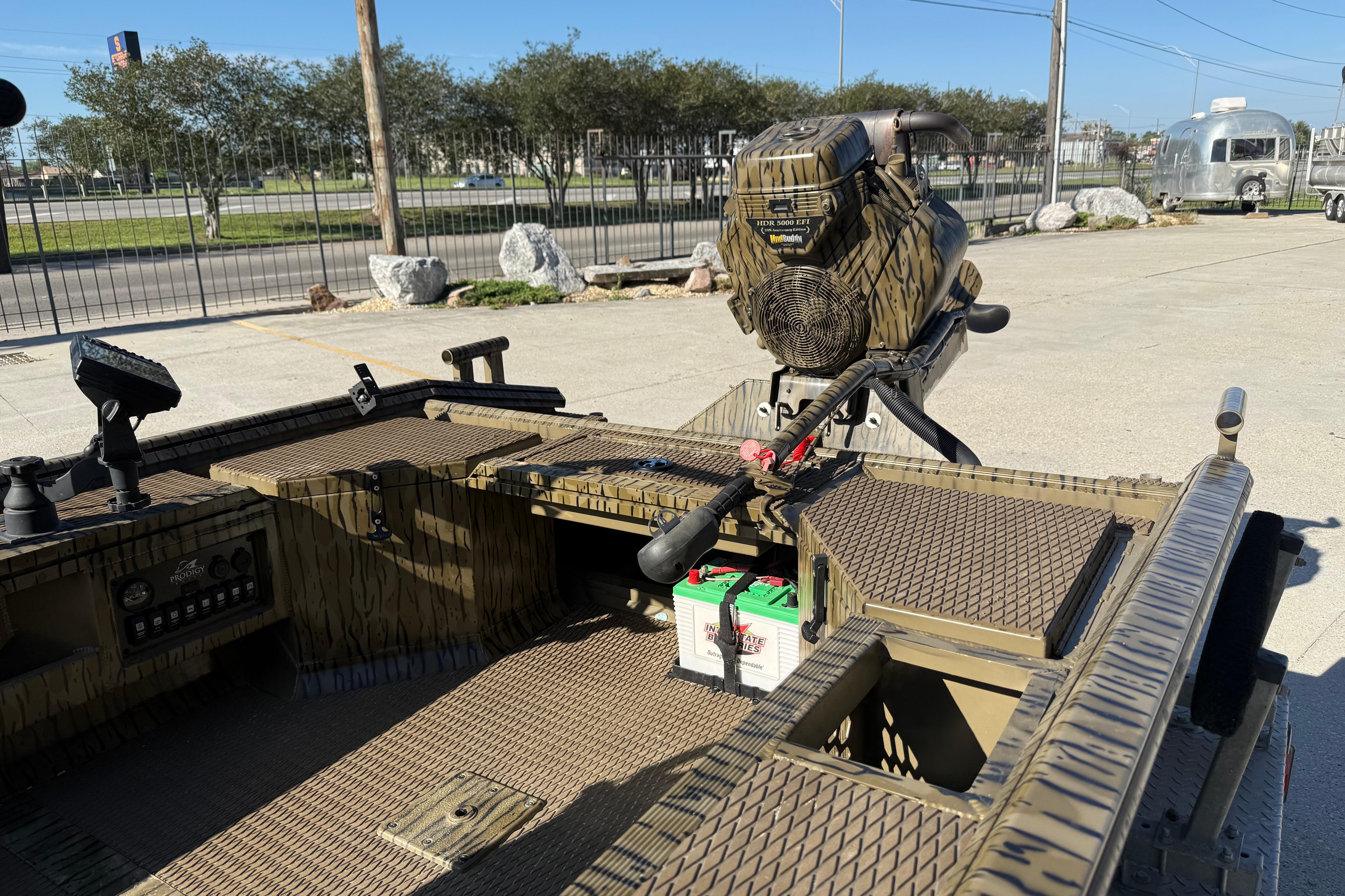 Prodigy 1854 boat, 2022 model, featuring a camouflage design and advanced motor setup.