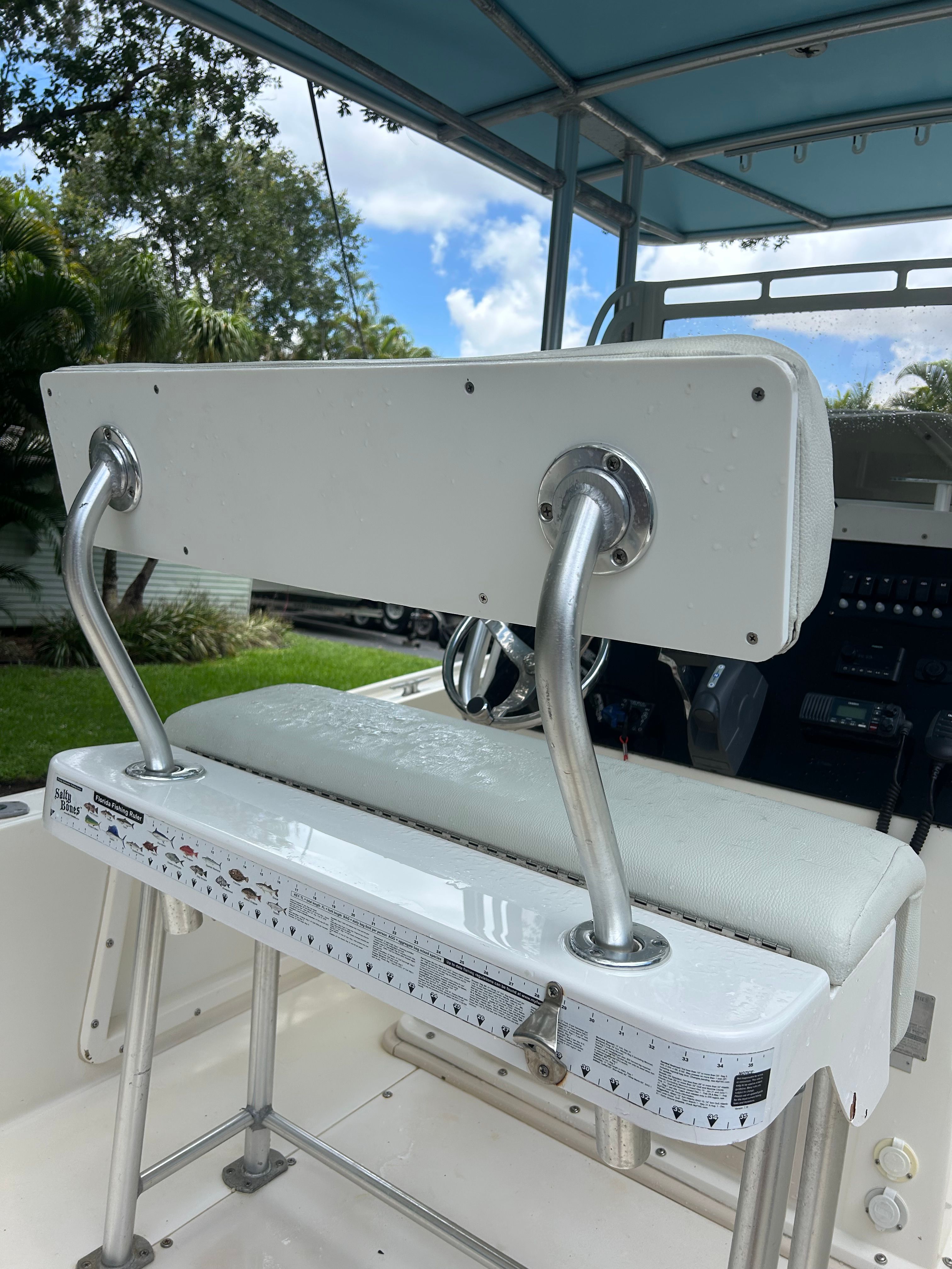 Rear bench of a 1992 Mako 221 boat under blue sky.
