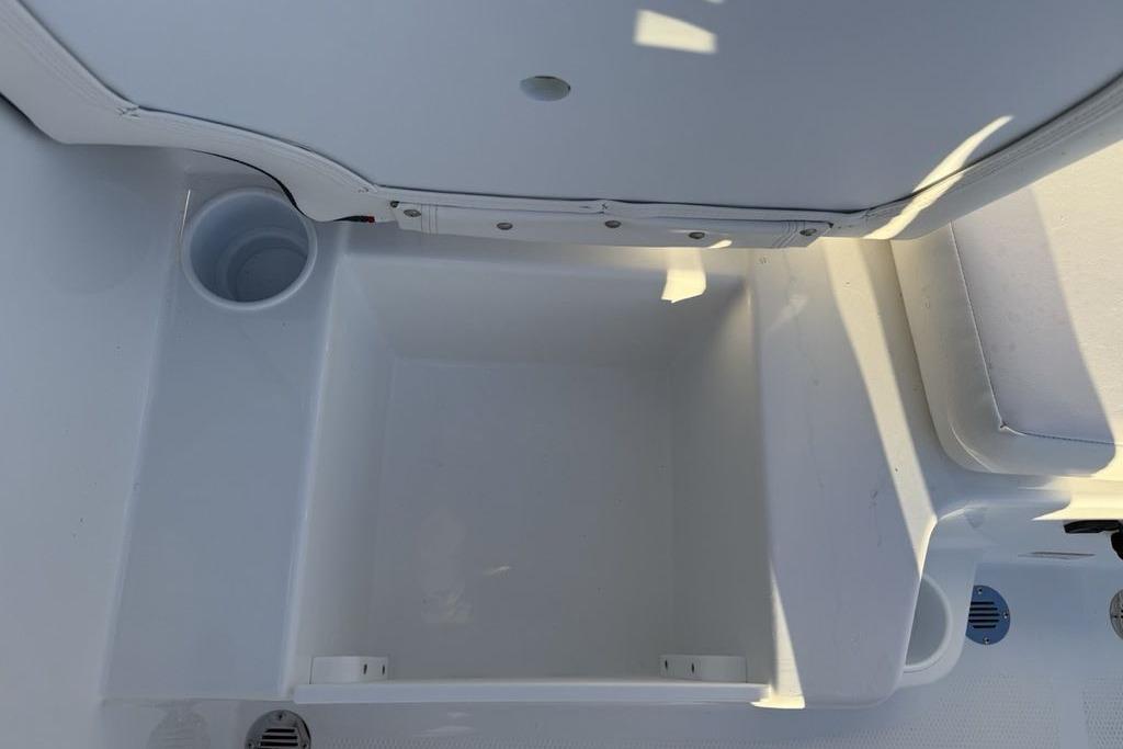Interior view of 2026 Tahoe T16 boat storage compartment with cup holder.