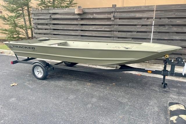 2026 Tracker Grizzly 1648 Utility boat on trailer, parked outdoors.