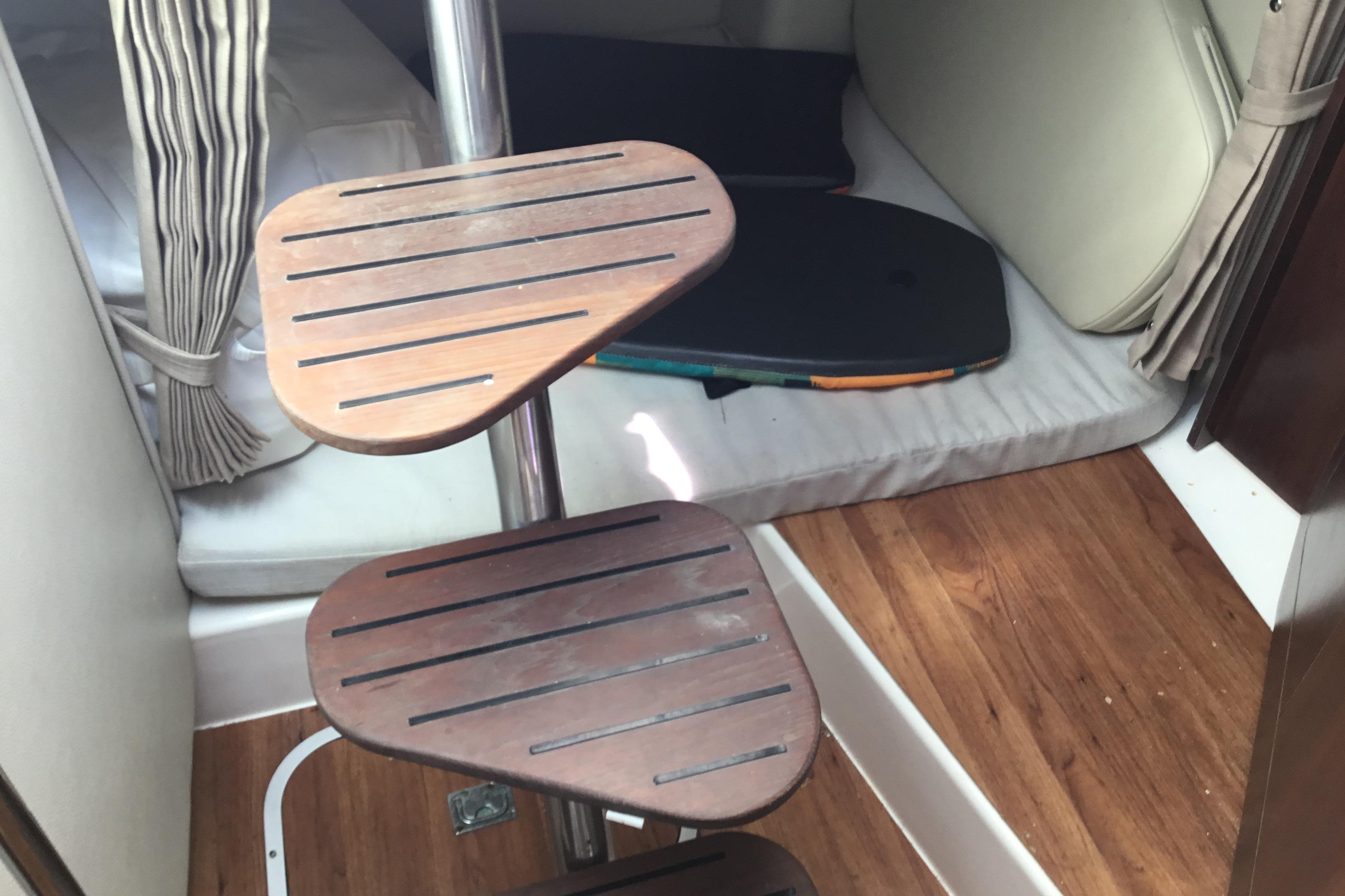 Interior of 2017 Robalo R305 Walkaround boat with wooden steps and cozy cabin space.