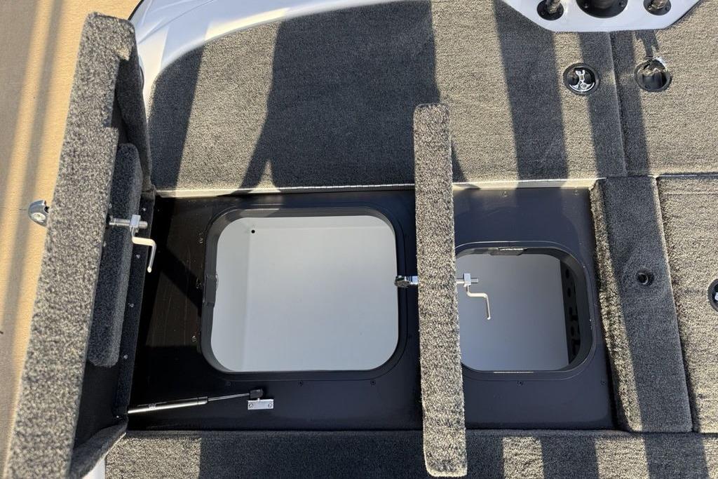 2026 Skeeter ZXR19 SE boat storage compartments with open hatches and carpeted interior.