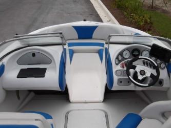 2004 Mariah SK-10 boat interior with blue and white seating and dashboard controls.