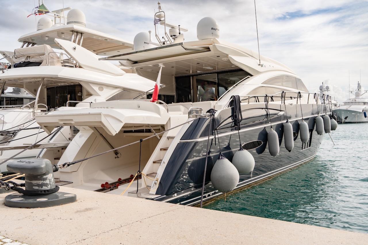Luxury 2012 Princess V72 yacht docked at marina, featuring sleek design and fenders.
