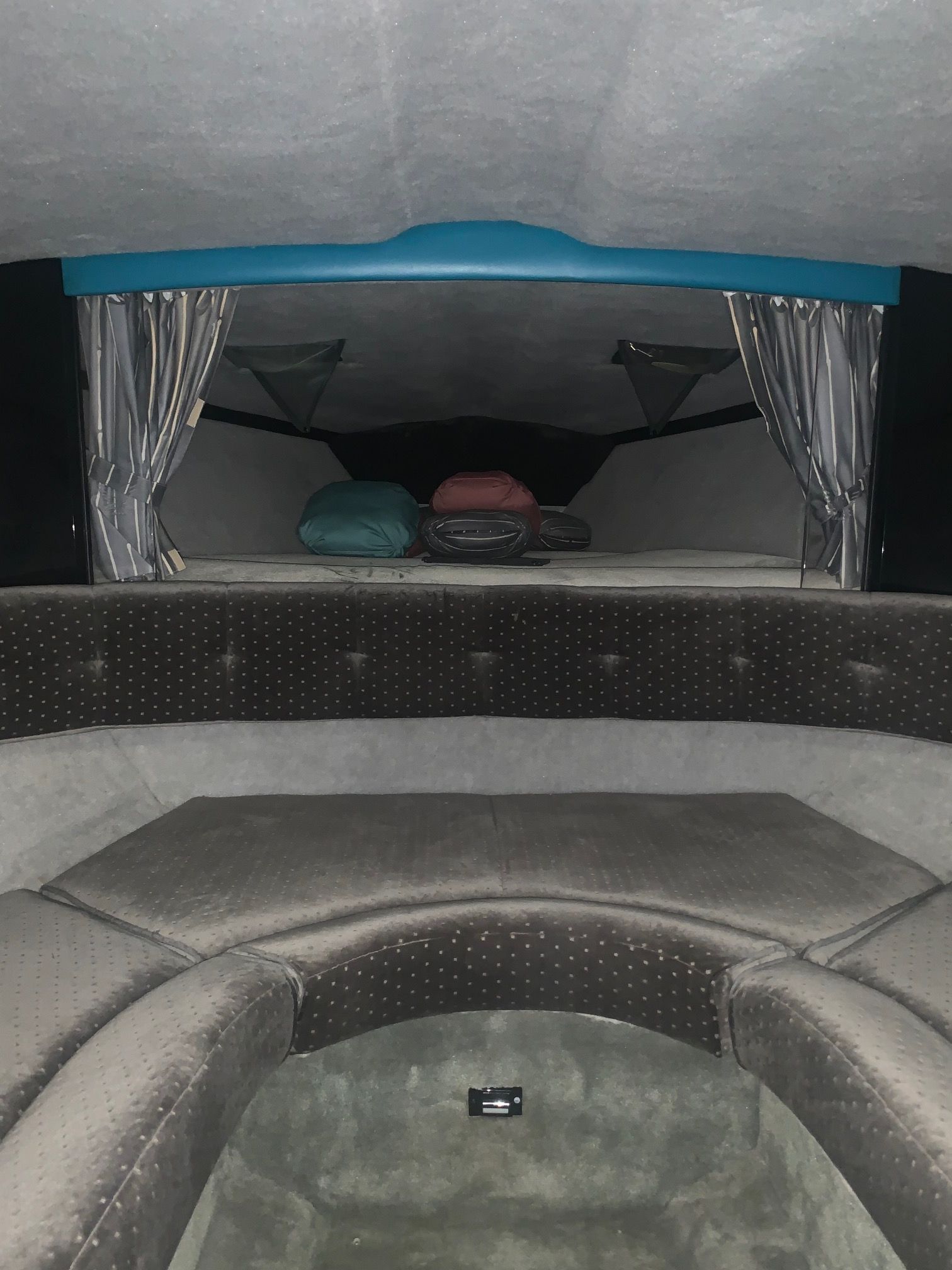 Interior of a 1988 Formula 311 SR1 with cushioned seating and sleeping area.