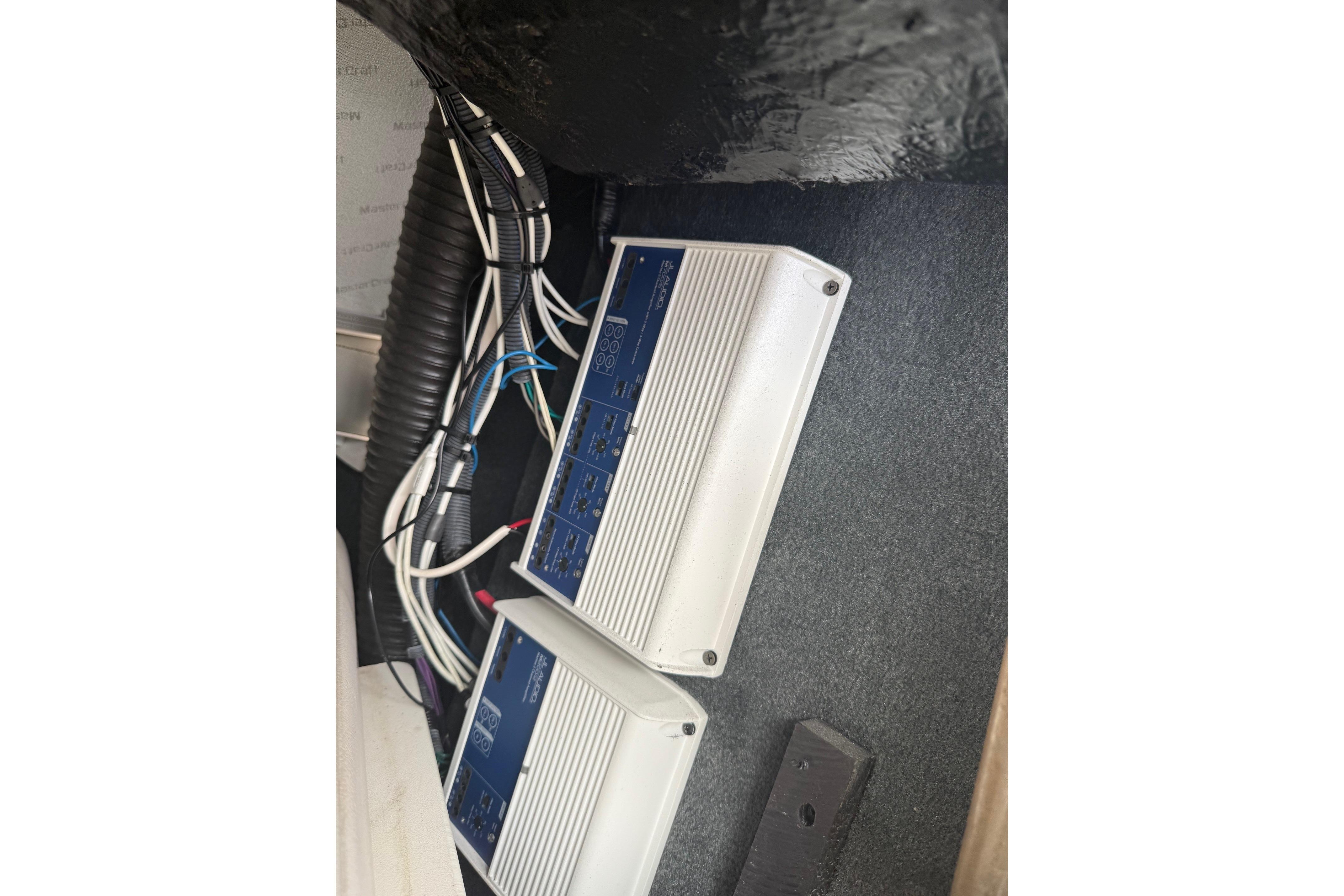 Audio amplifiers in a 2008 MasterCraft X-15 boat, showcasing wiring and installation.