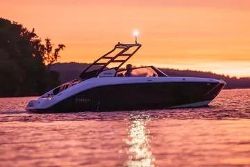 2026 Yamaha Boats 222SE cruising at sunset on a serene lake.