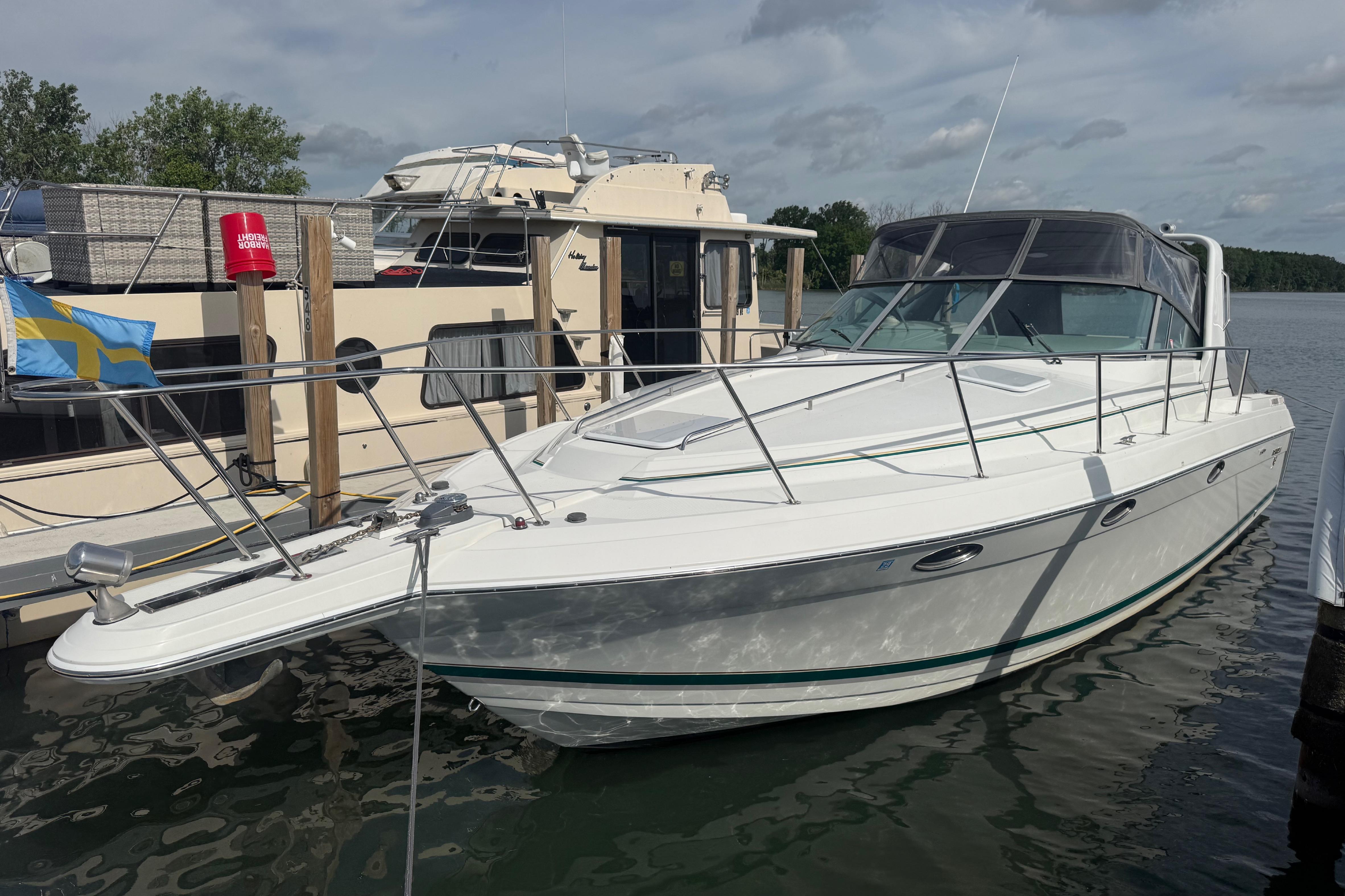1999 Formula 34 Performance Cruiser docked at marina, featuring sleek white design and spacious deck.
