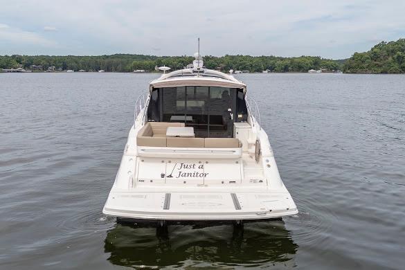 2016 Sea Ray Sundancer 510 yacht on calm lake waters, rear view.