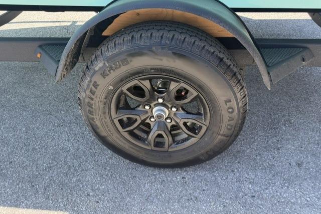 2026 Tahoe T18 trailer wheel with black alloy rim on asphalt surface.