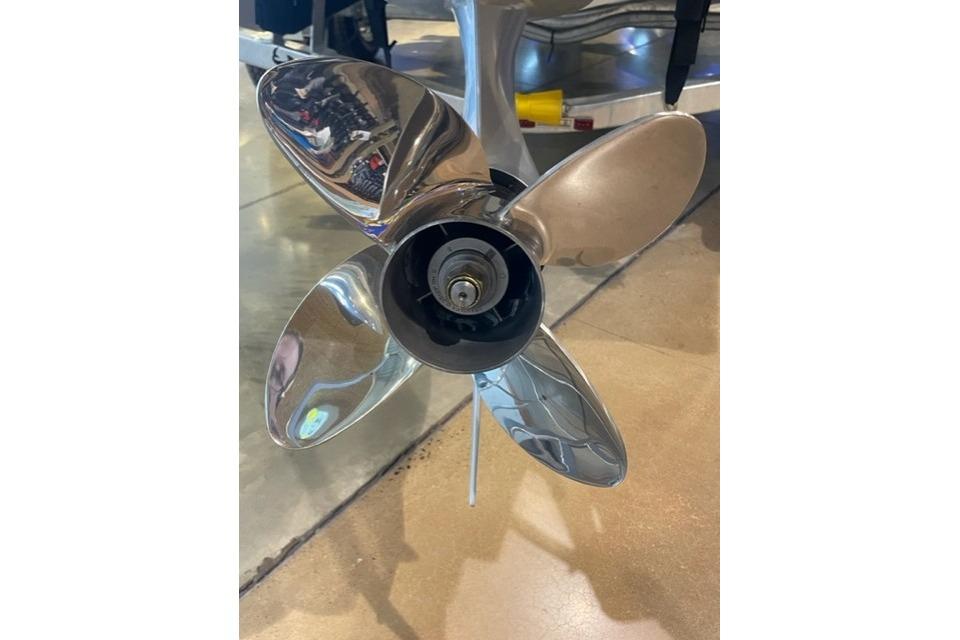 2026 Mako 24 APEX boat propeller, shiny metal blades on display.