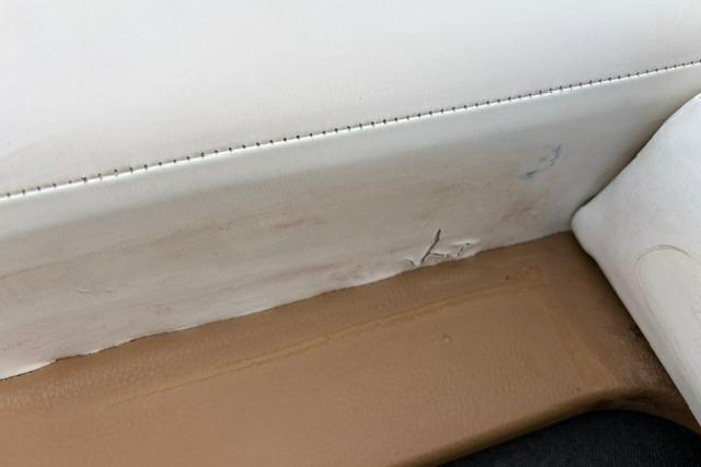 Interior detail of 2017 Searay SPX210 boat showing upholstery stitching and minor wear.