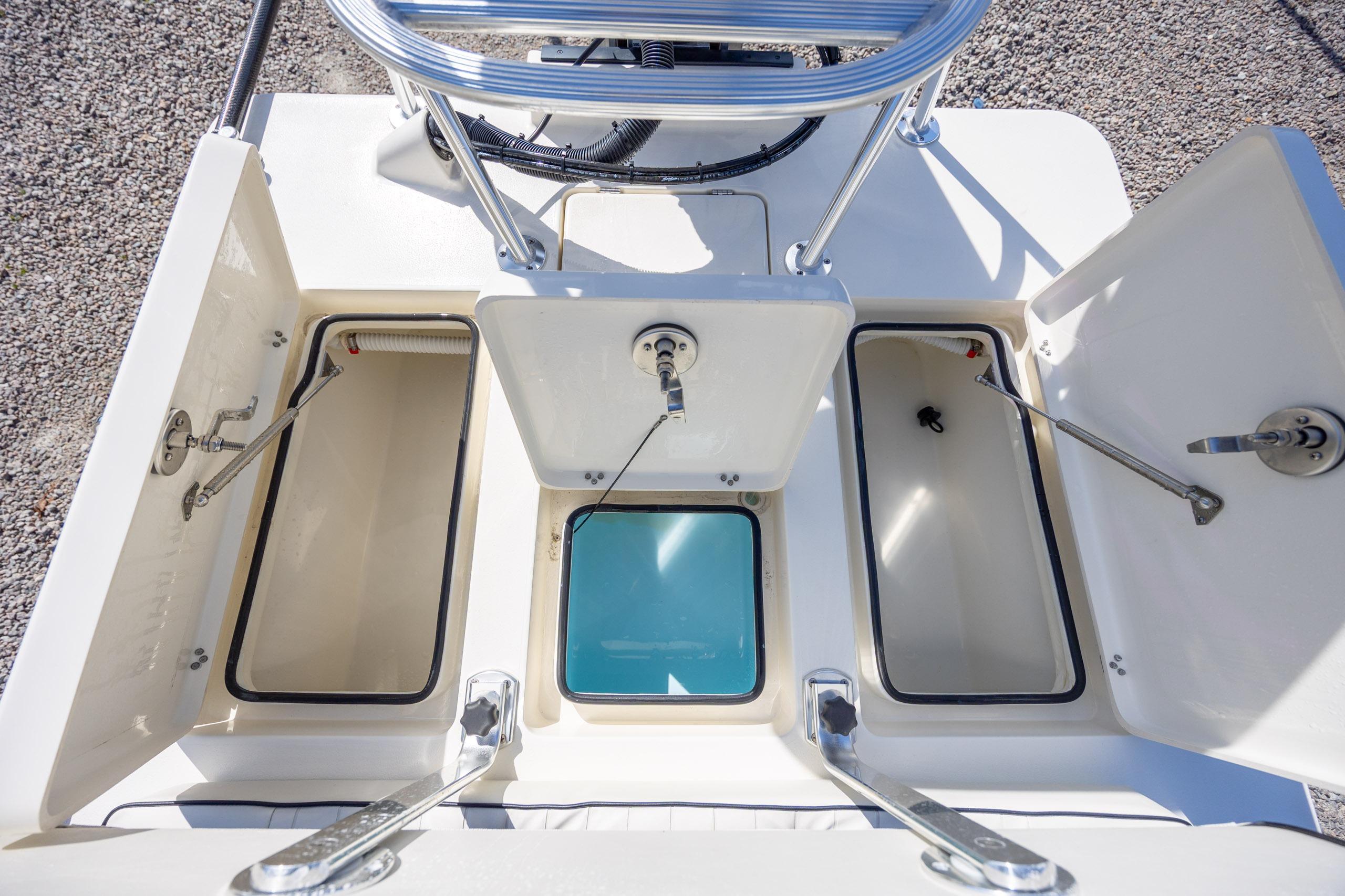 2024 Maverick 17 HPX-S boat storage compartments with open hatches, showcasing interior design.