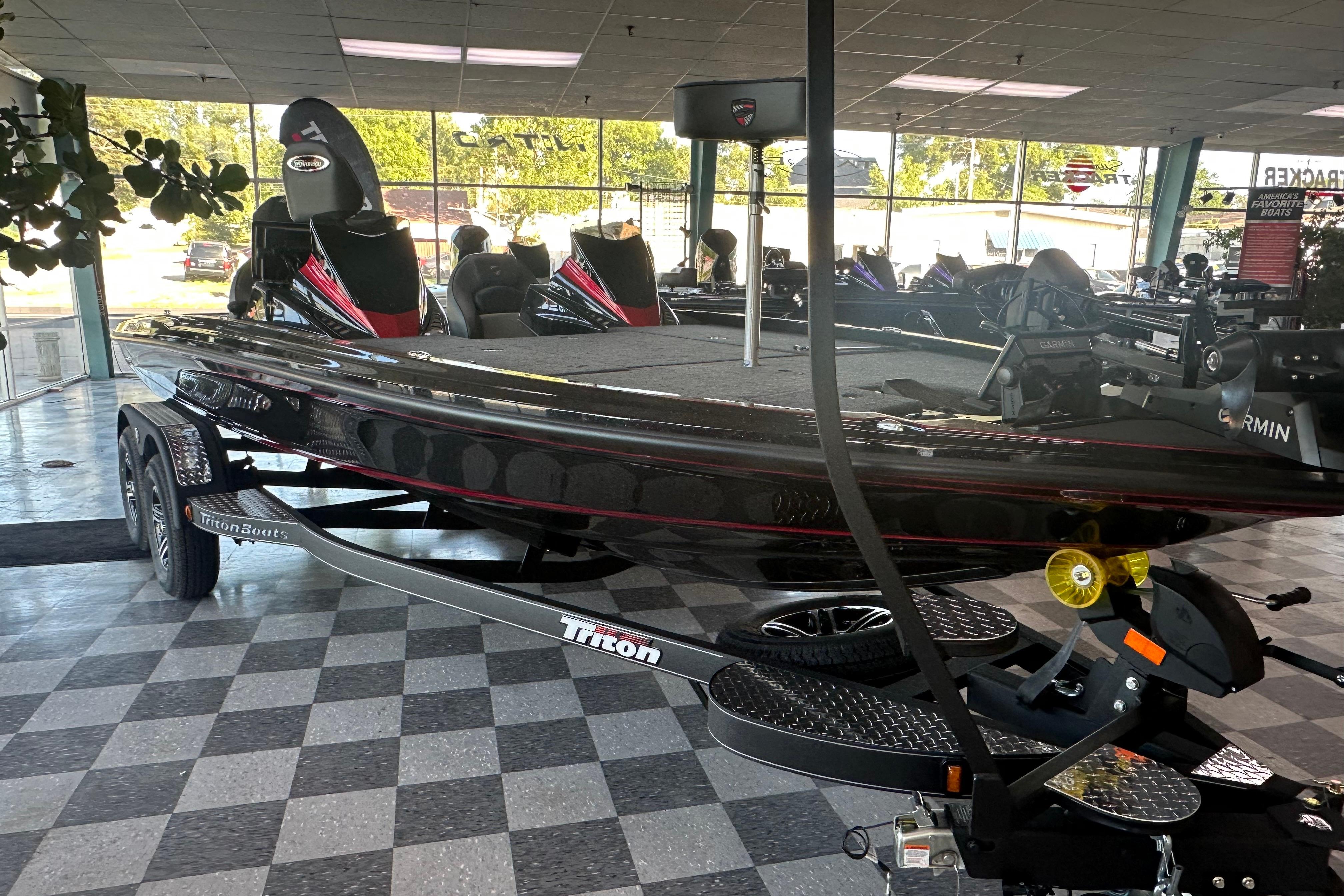 2026 Triton 20XP Patriot boat displayed in showroom, featuring sleek design and advanced equipment.