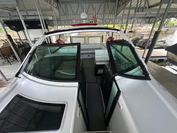 2022 Cobalt A36BR boat docked under a covered marina, showcasing sleek design and spacious interior.