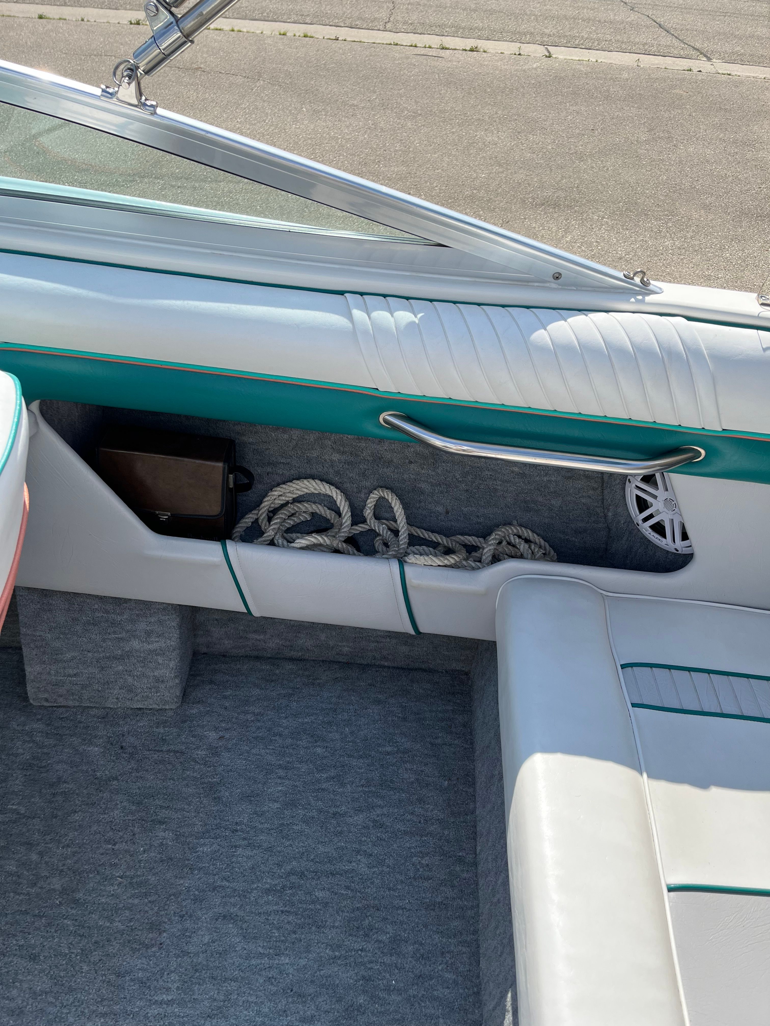 Interior view of a Sea Ray 220 Bow Rider with ropes and speaker.