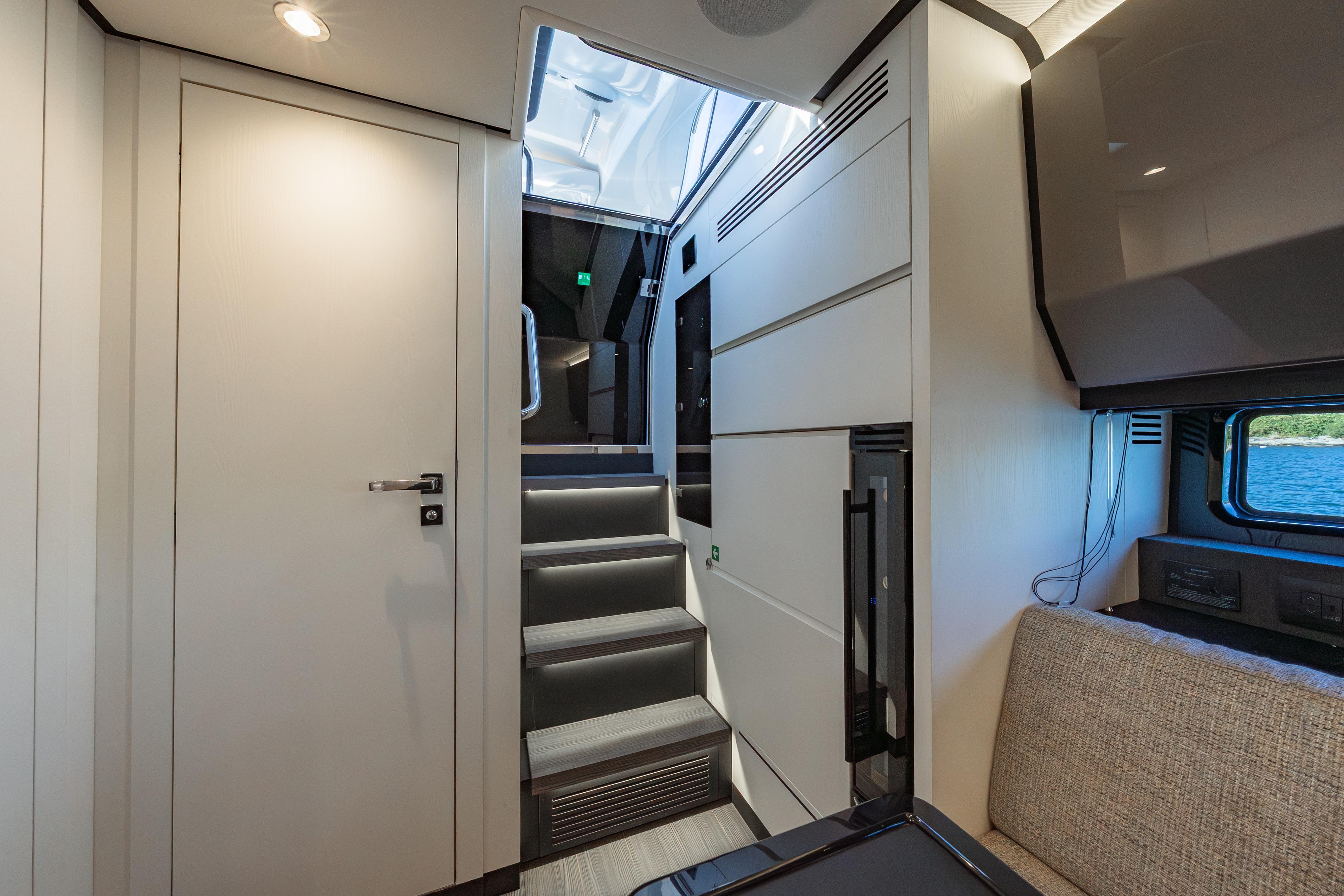 Interior of 2023 Azimut Verve 47 yacht, featuring modern design and elegant staircase.