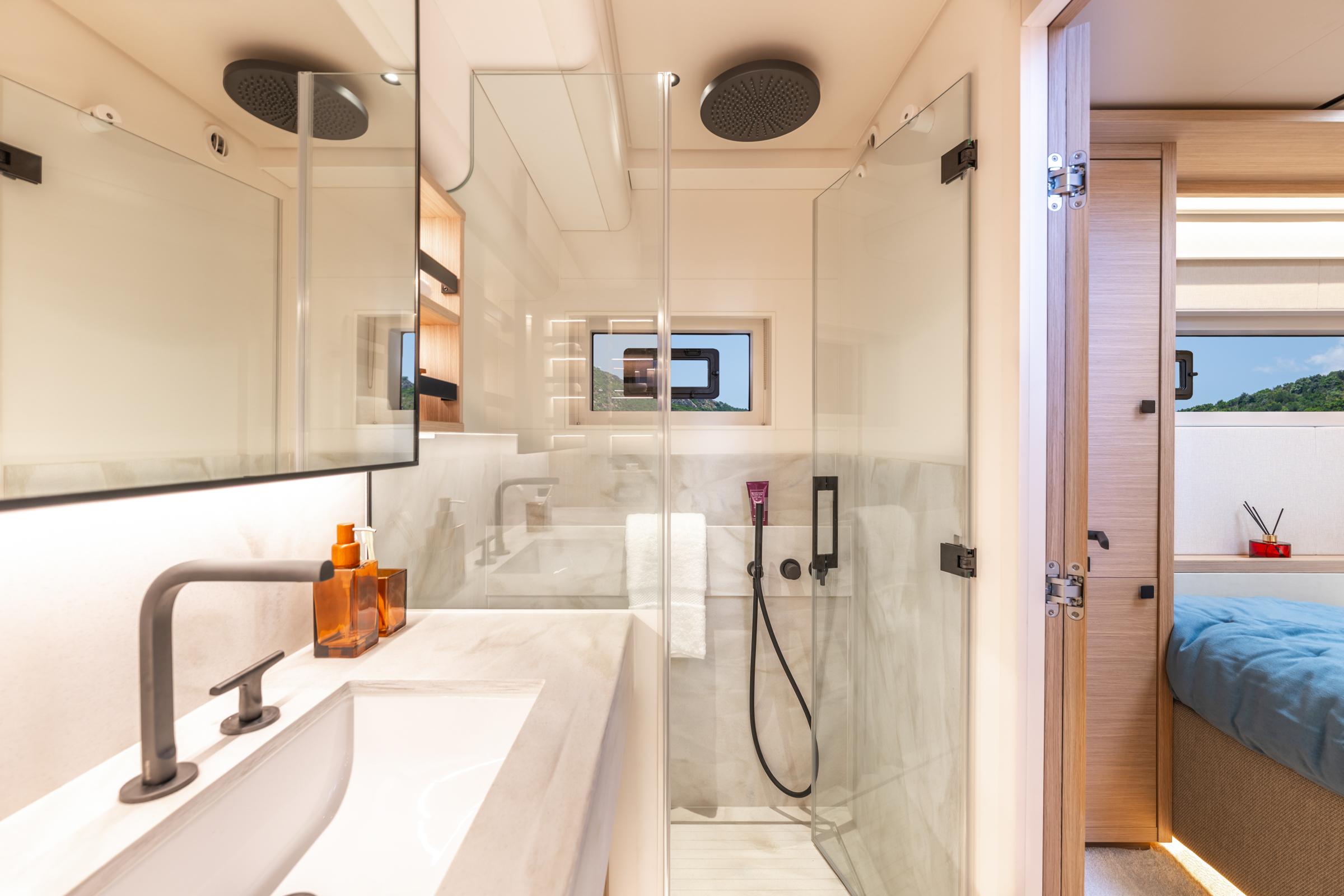 Luxurious bathroom interior of 2025 Lagoon Eighty 2 yacht with modern fixtures and glass shower.