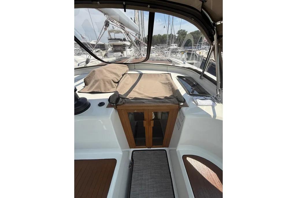 Cockpit view of 2016 Bavaria Vision 46 sailboat, featuring covered seating and wooden accents.