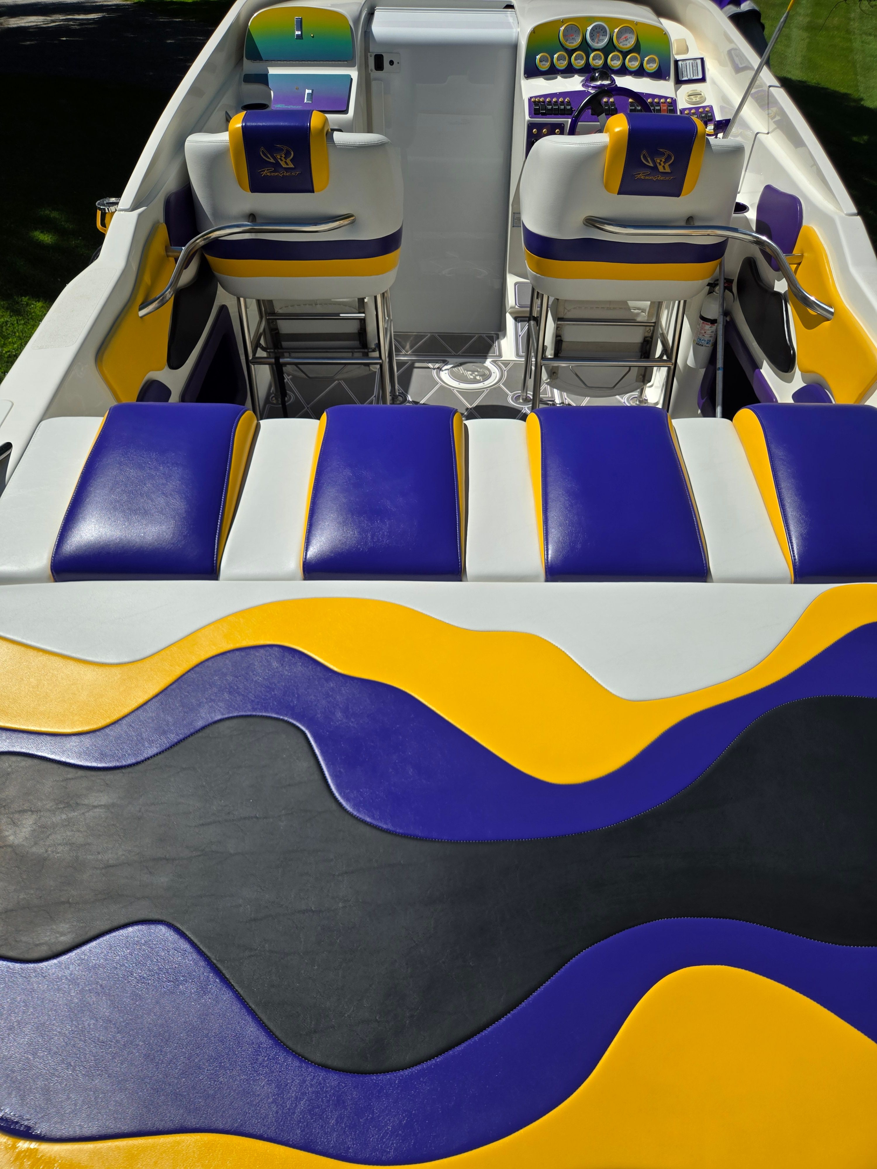 Interior of a Powerquest 340 Vyper boat with colorful seats and dashboard.