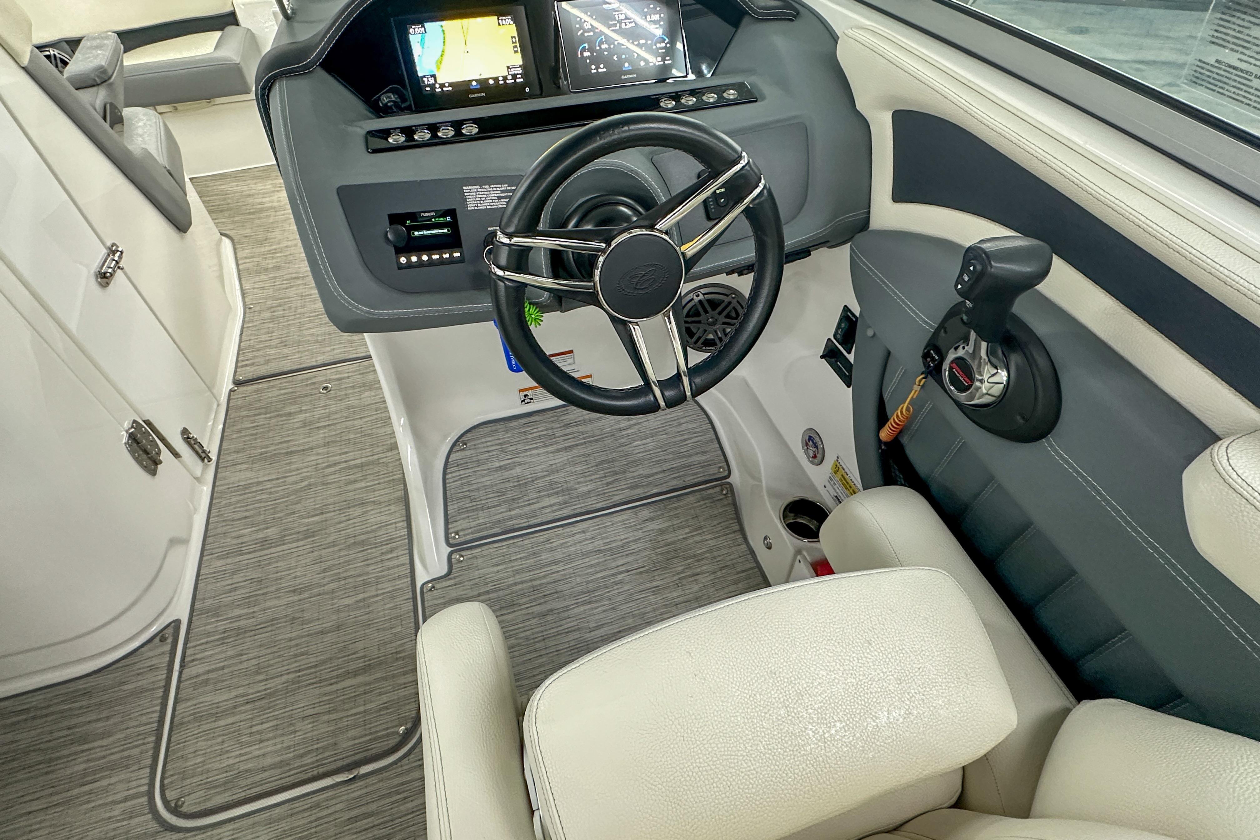 2022 Cobalt 25SC boat cockpit with steering wheel and control panel.