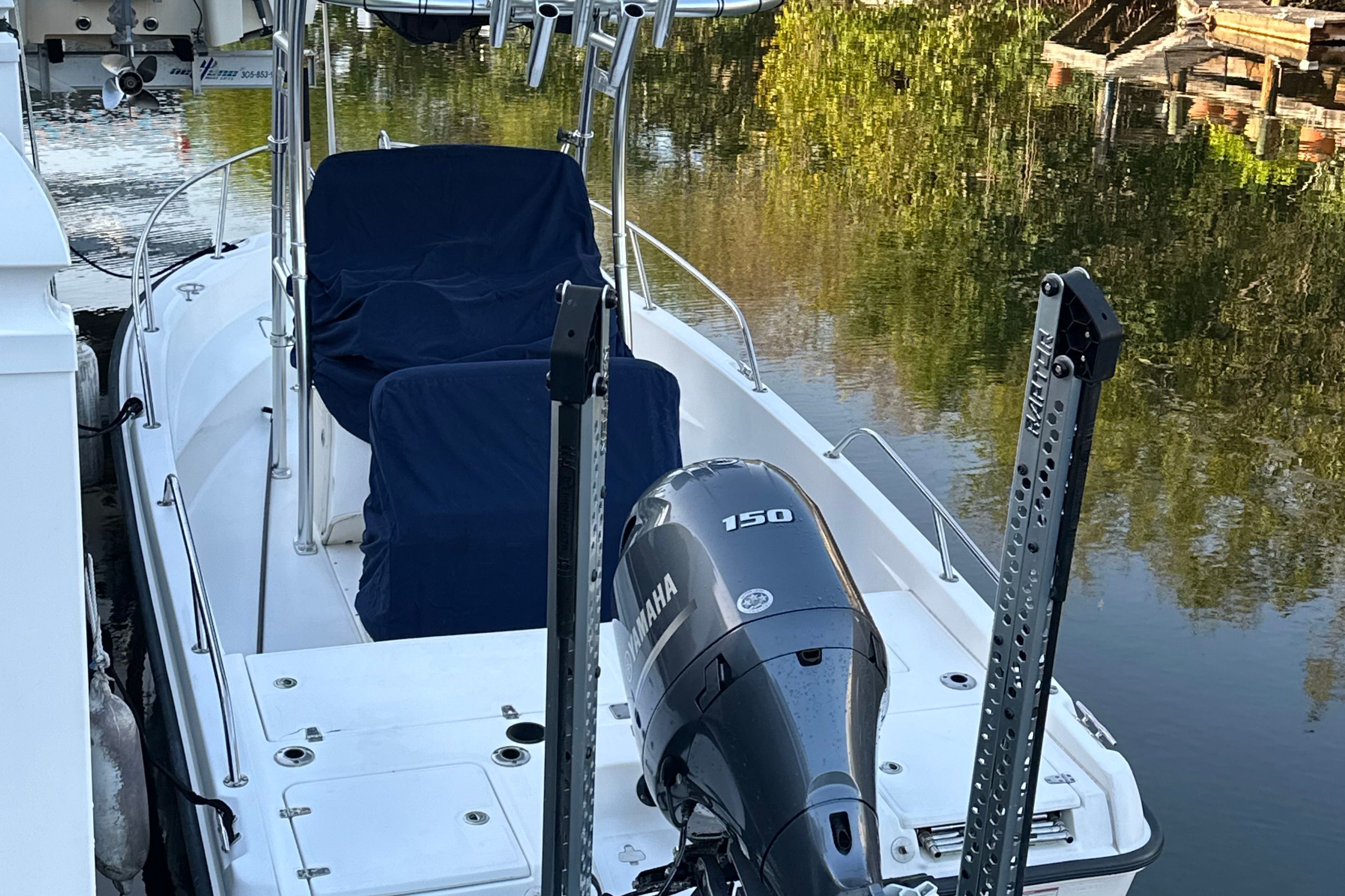 A 2009 Boston Whaler 180 Dauntless docked. It features a Yamaha outboard motor.