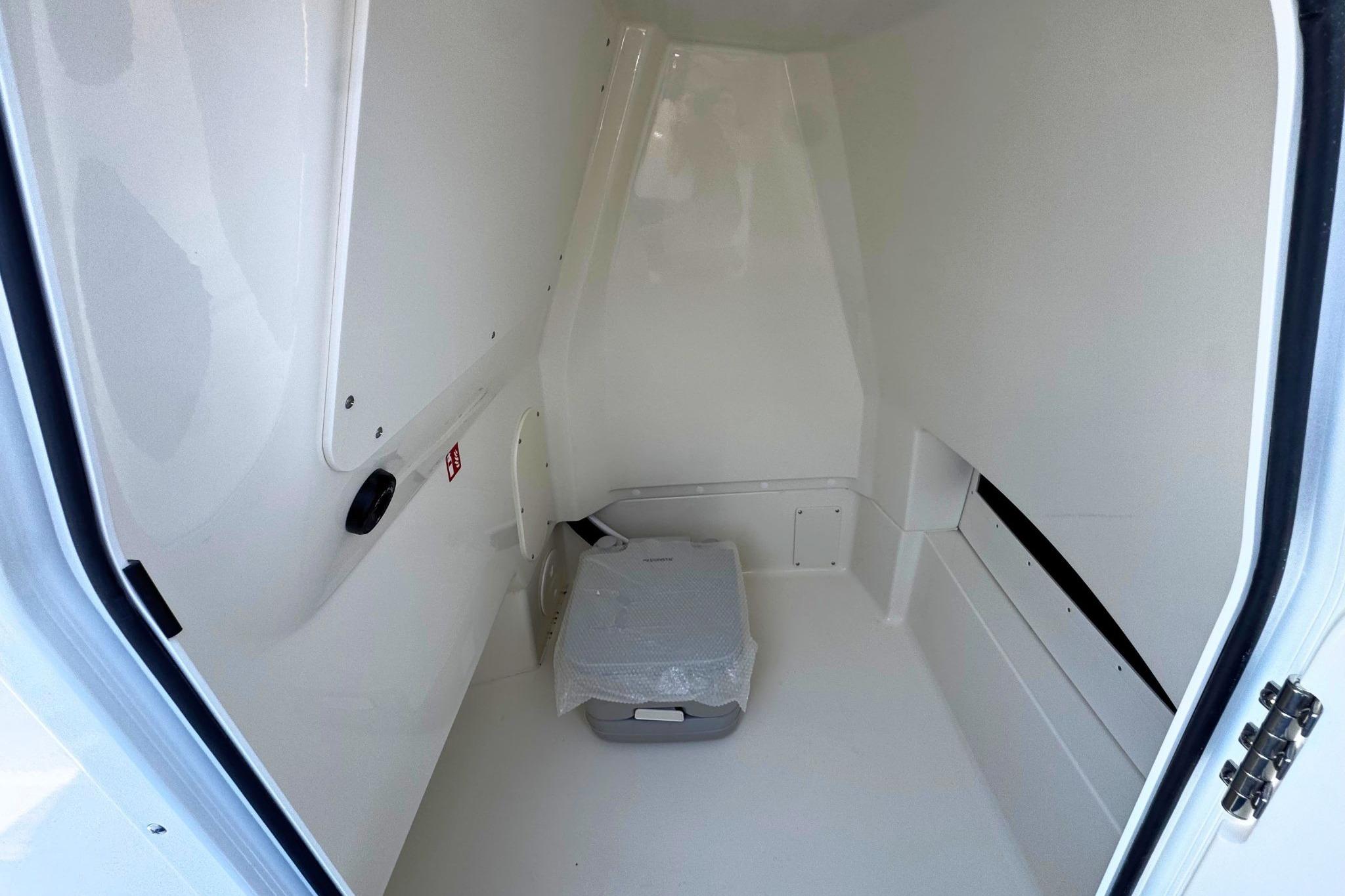 Interior cabin of 2026 Boston Whaler 220 Dauntless, featuring a compact, clean design.